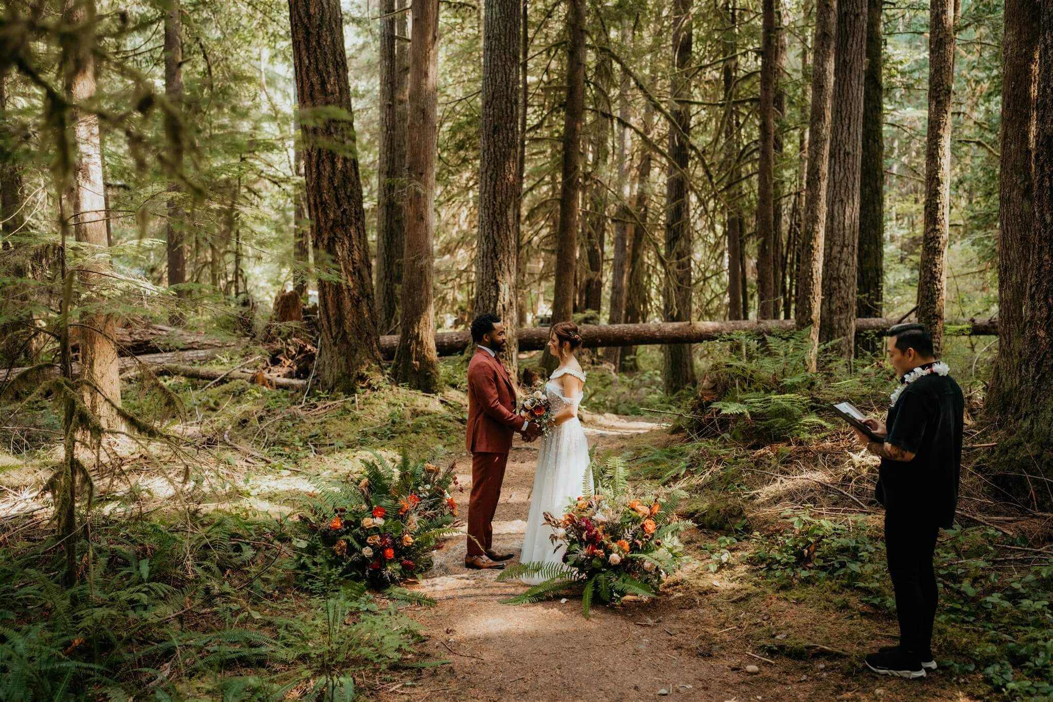 Bride and groom elopement ceremony in the forest 