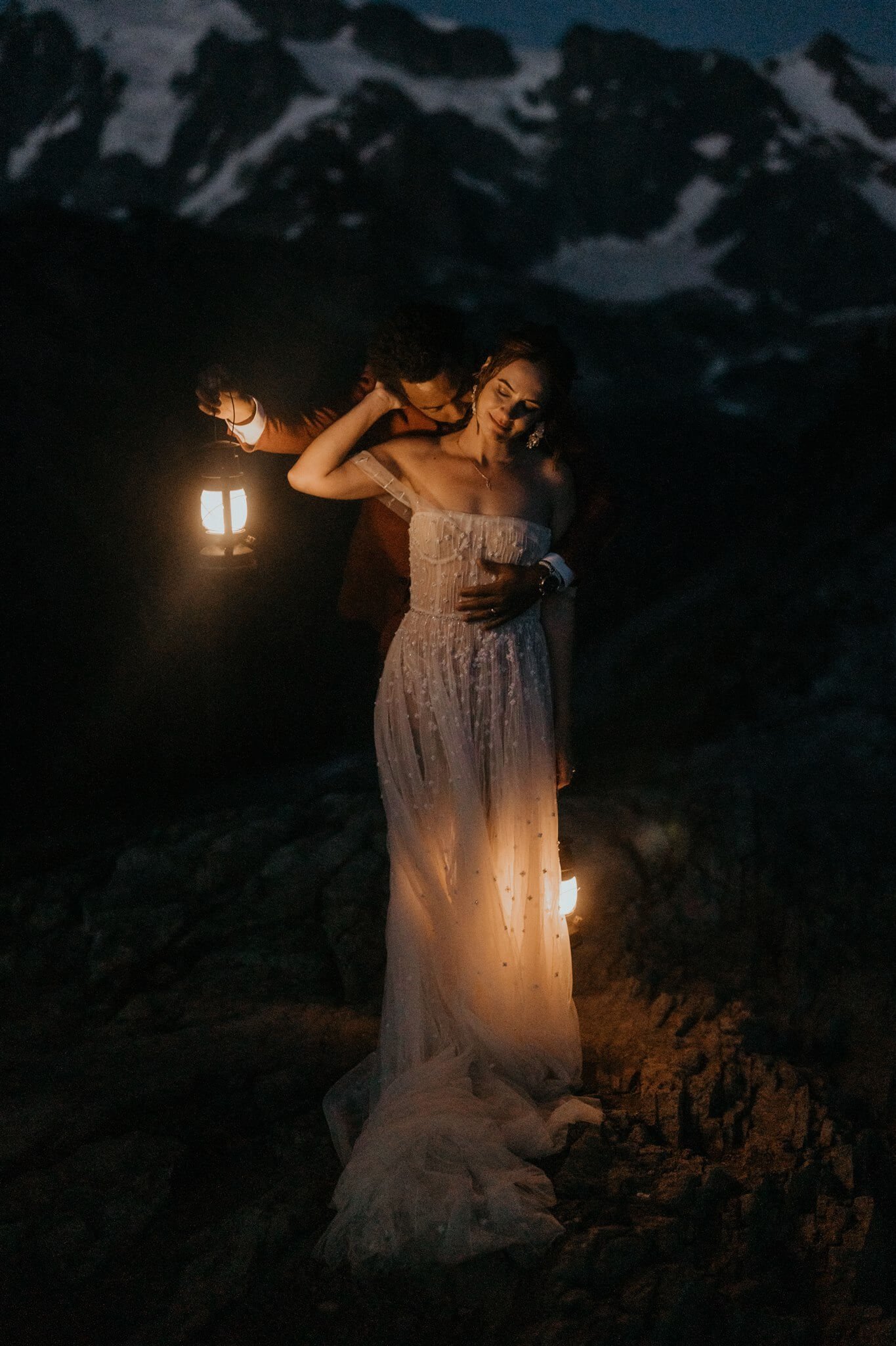 Blue hour portraits of bride and groom holding lanterns at their mountain elopement in the North Cascades