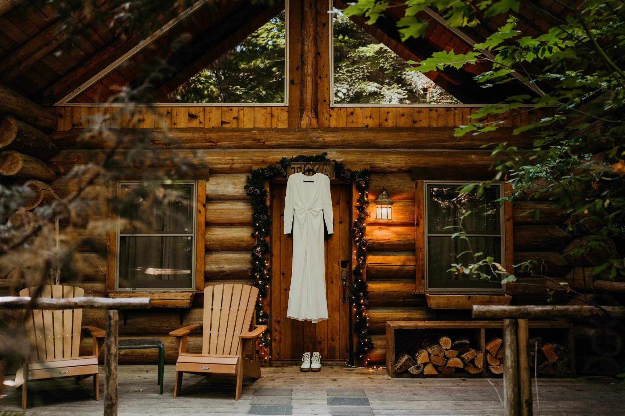 White Galia Lahav wedding dress hanging on the door of wood cabin at Wellspring Spa
