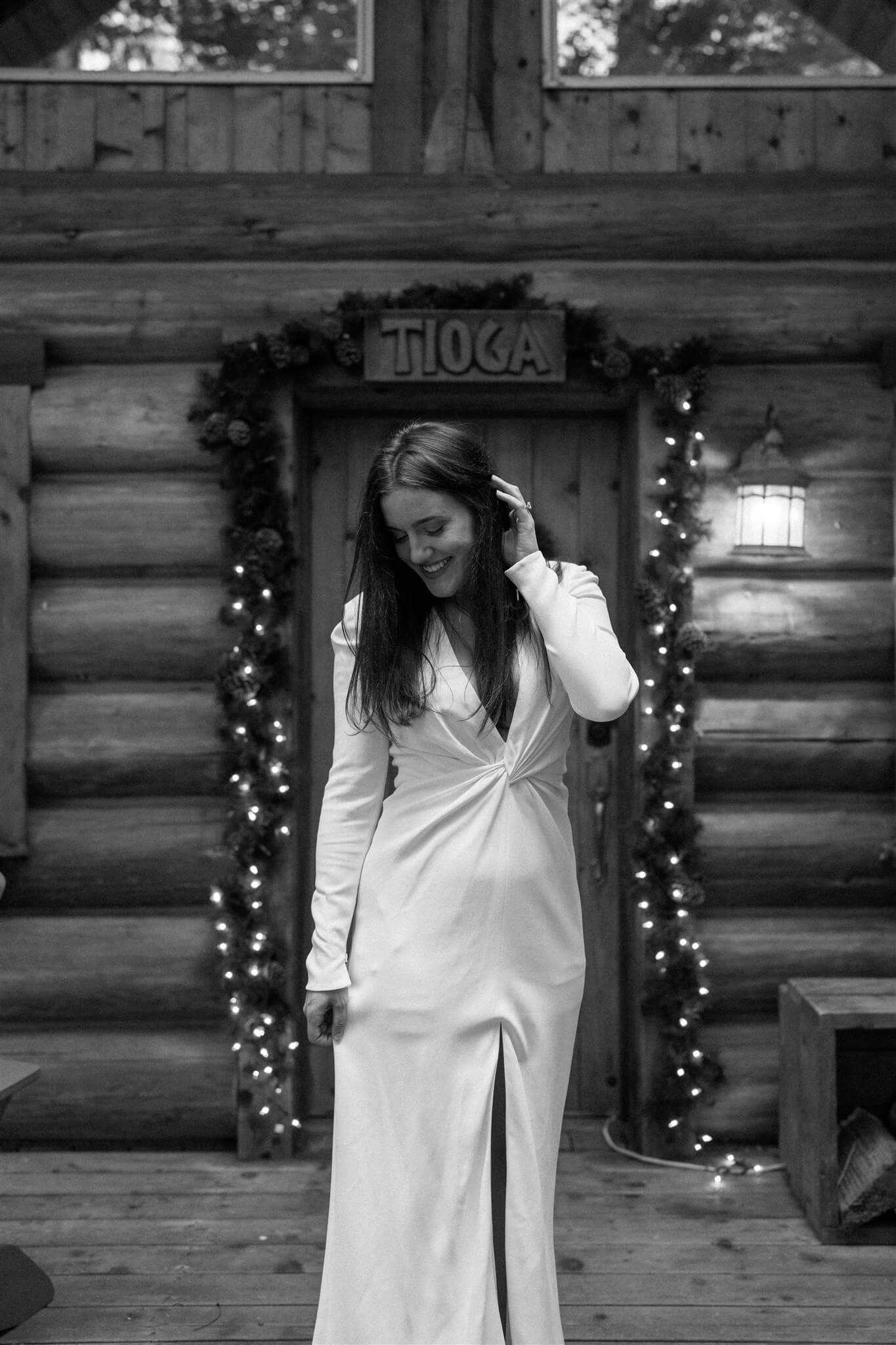 Bride wearing white Galia Lahav wedding dress and coming out of cozy cabin at Wellspring Spa
