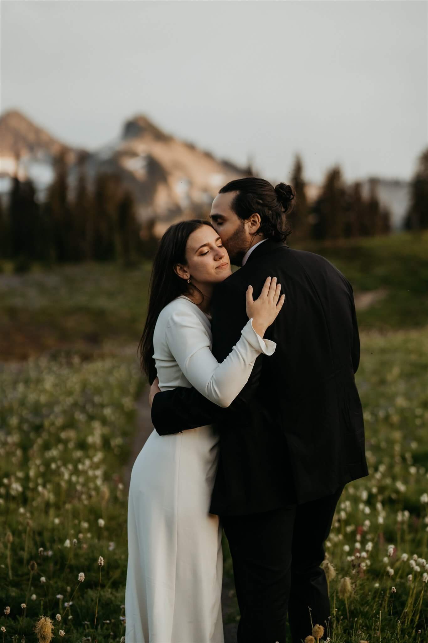 Bride and groom hug during couple photos at their Mount Rainier adventure wedding