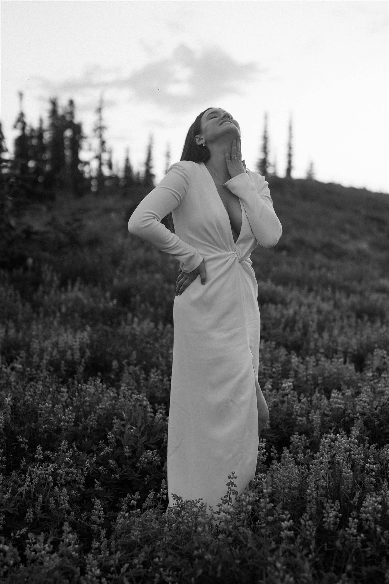 Bride wearing a white Galia Lahav wedding dress and standing in a field at Mt Rainier