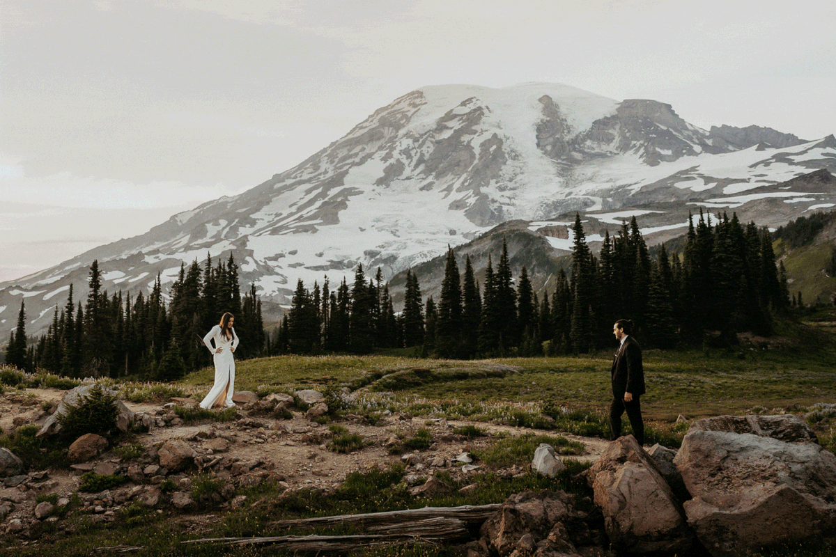 Bride and groom walking towards each other during Mount Rainier adventure wedding portraits