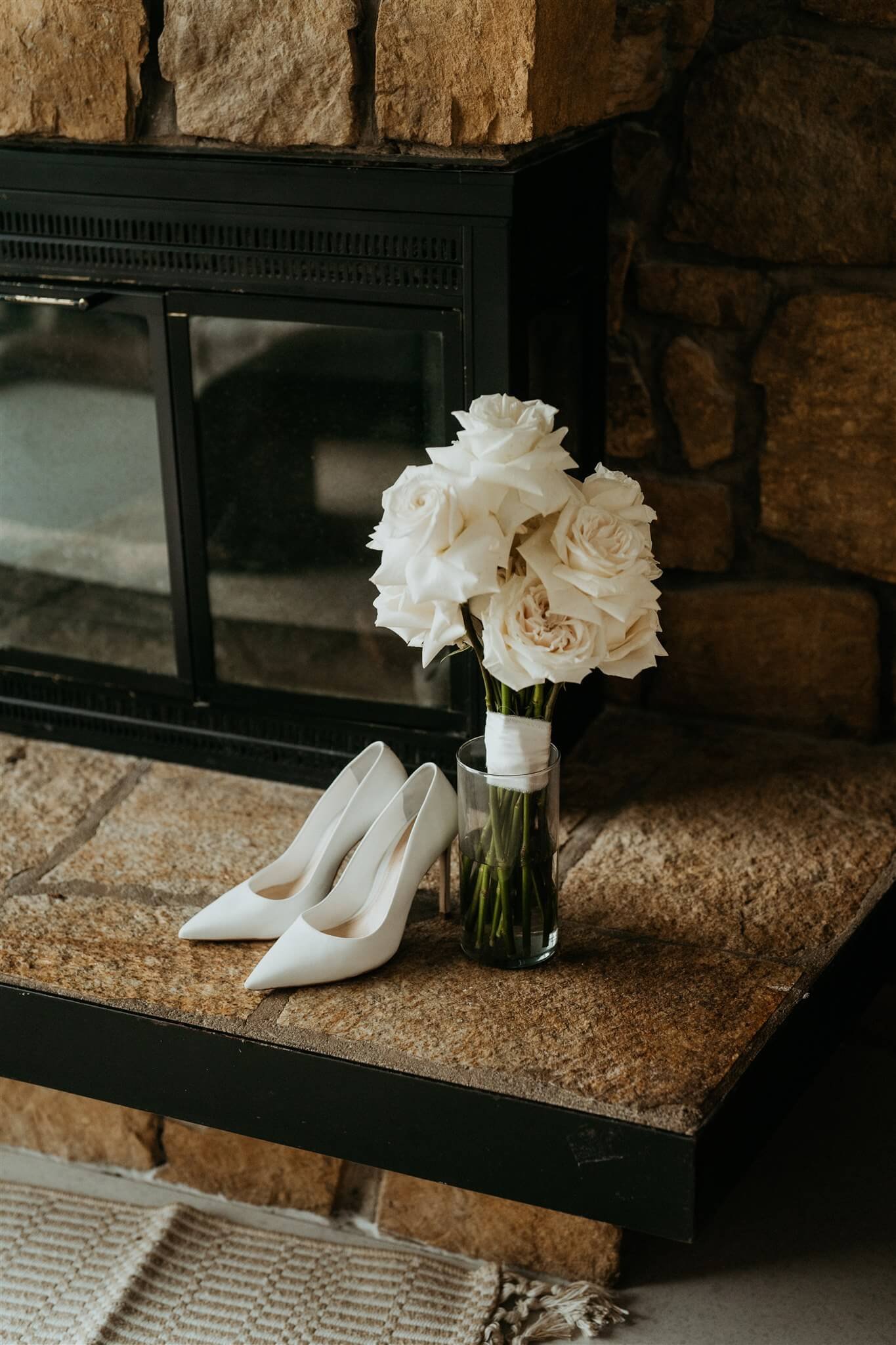 White wedding bouquet next to classy white wedding heels