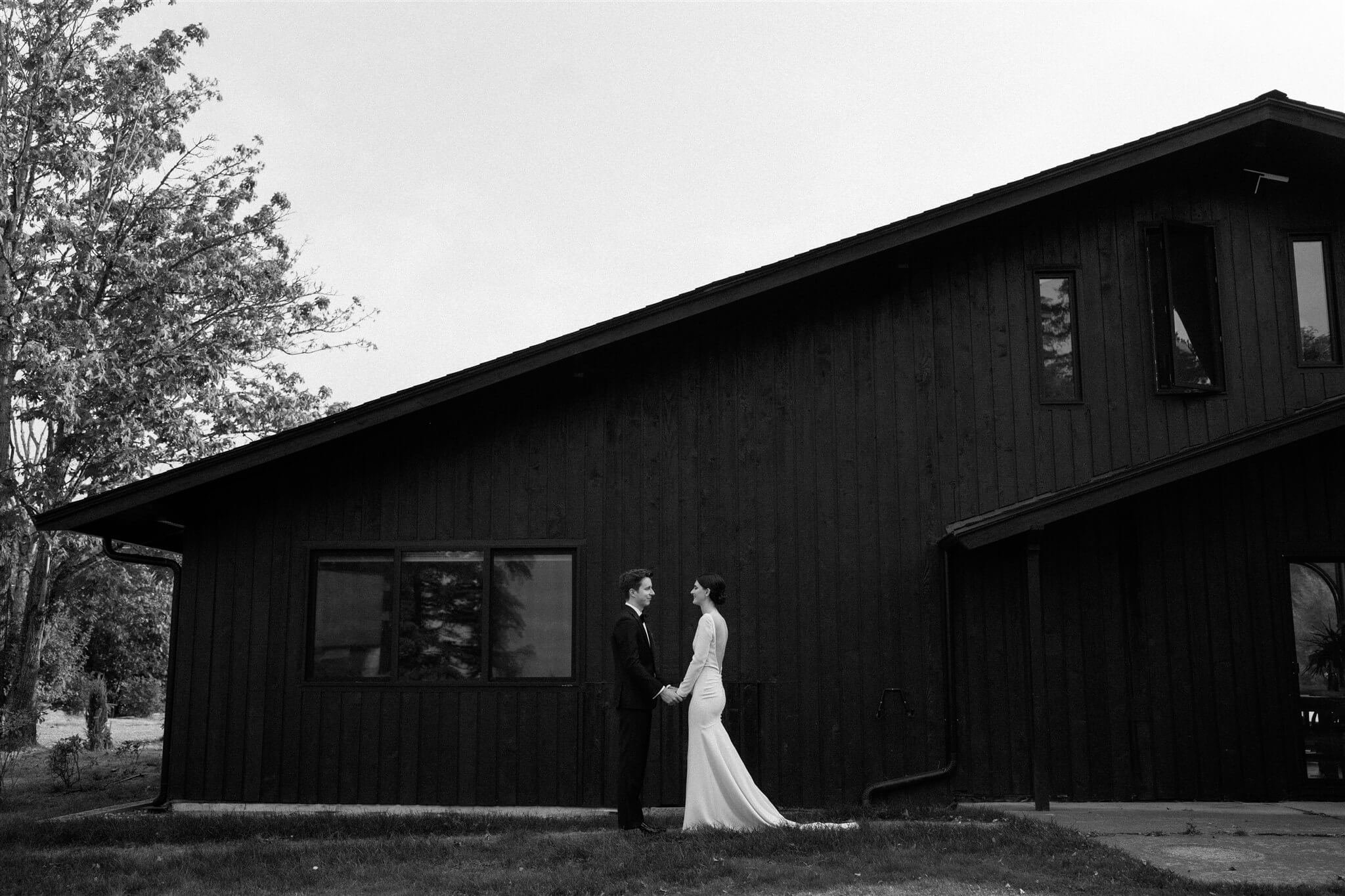 Bride and groom portraits in front of modern Airbnb cabin in the North Cascades