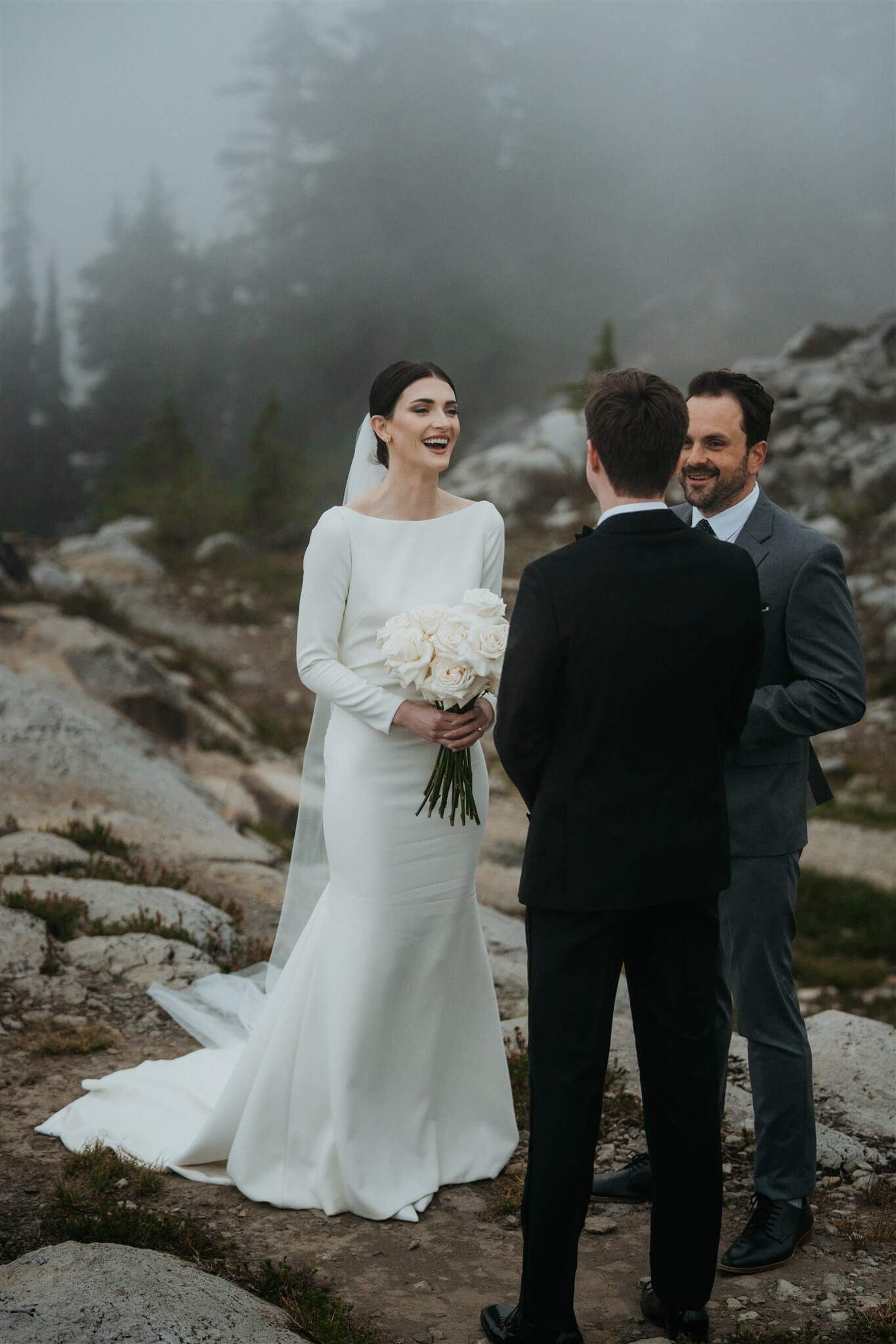 Bride and groom exchanging vows in the mountains at foggy Artist Point elopement