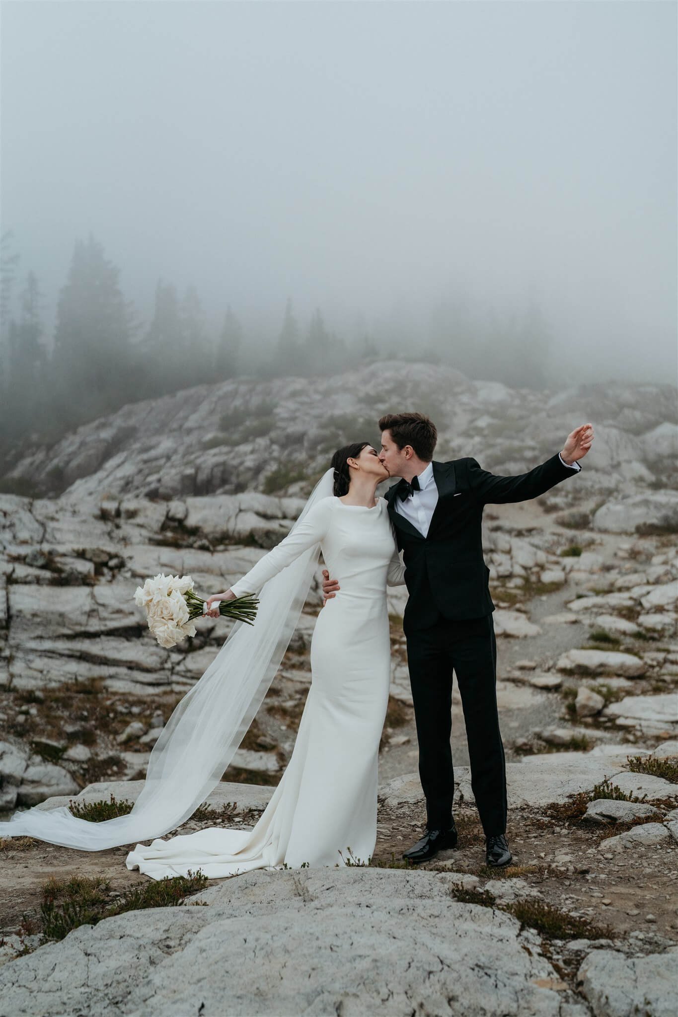 Bride and groom kiss after outdoor wedding ceremony in the North Cascades