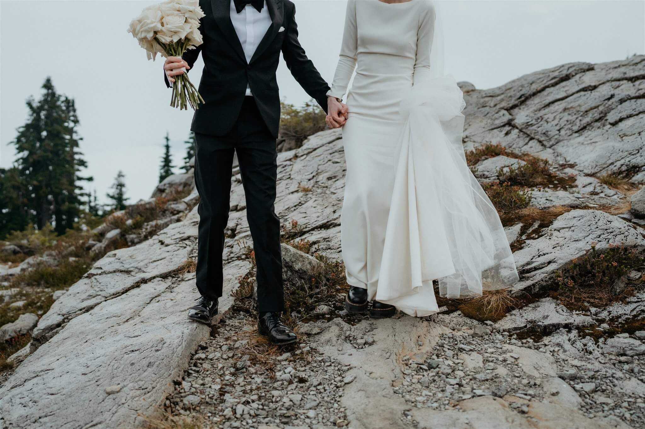 Bride and groom hold hands while hiking down the mountain at Artist Point in the North Cascades