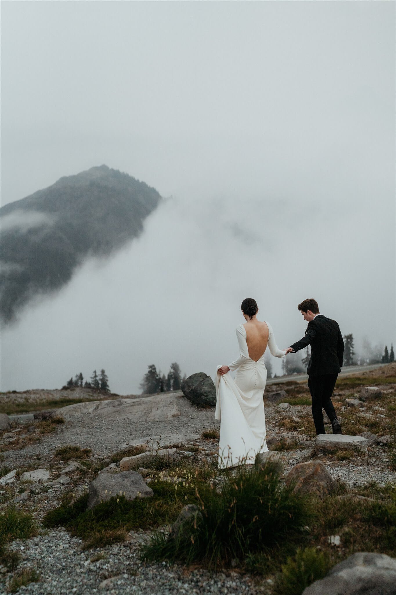 Bride and groom hold hands while walking through the trails at Artist Point in the North Cascades