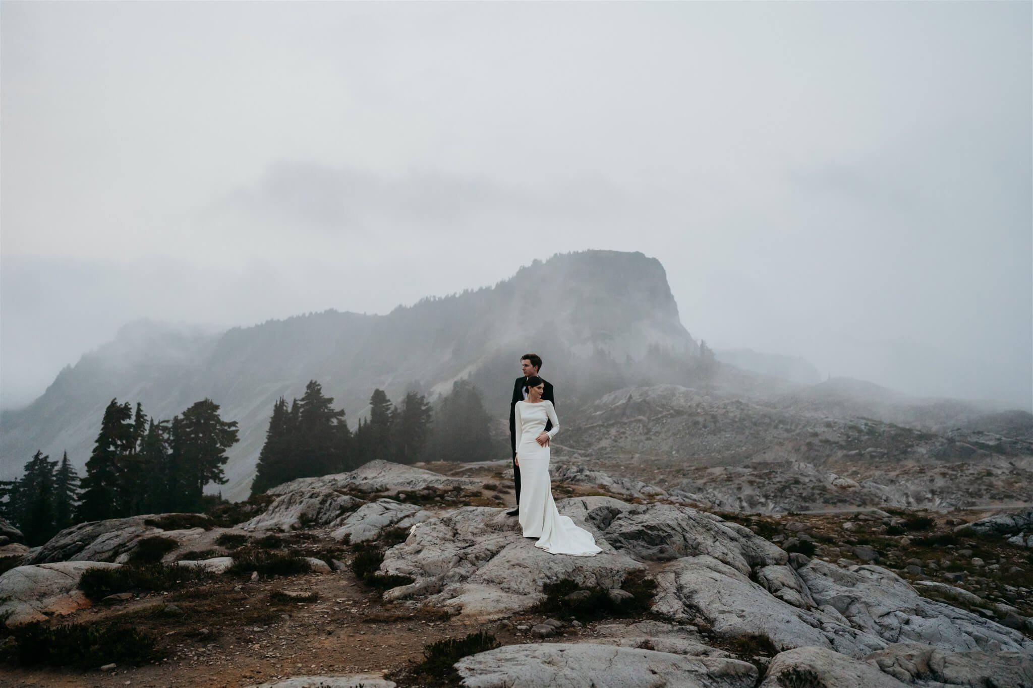 Bride and groom adventure portraits at foggy Artist Point elopement