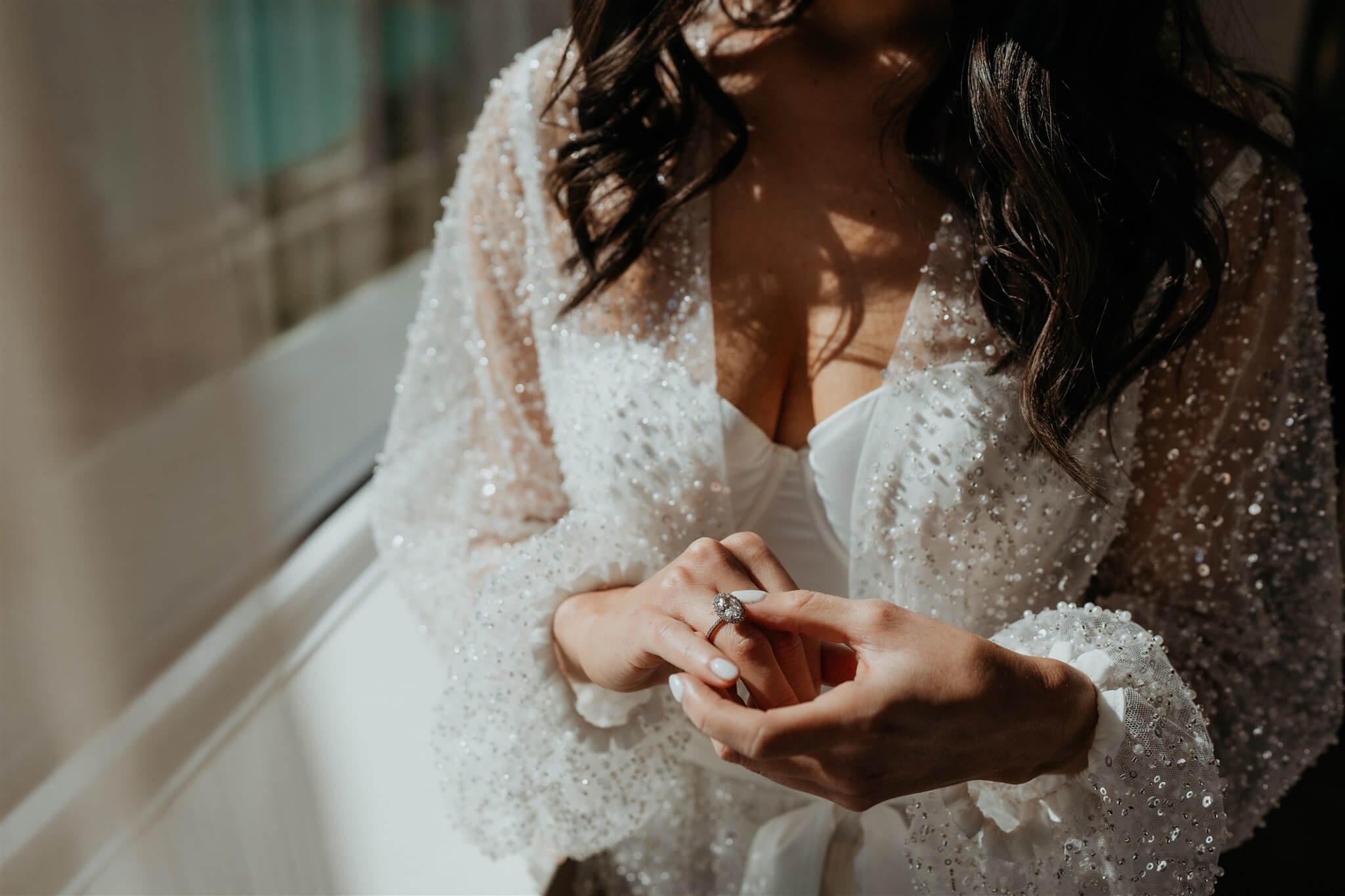 Bride wearing sheer sparkly robe while getting ready for Lake Louise wedding in Alberta, Canada