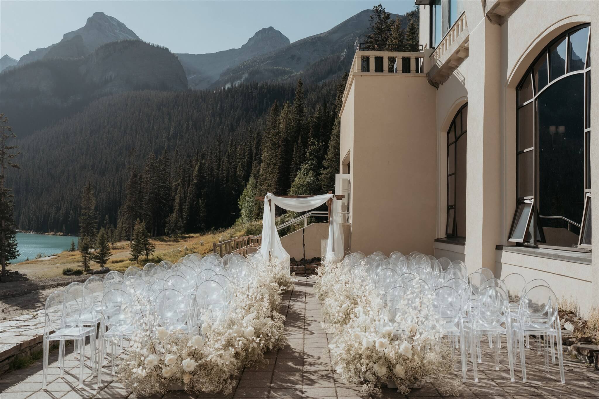 Outdoor wedding ceremony setup with white and gold wedding decorations