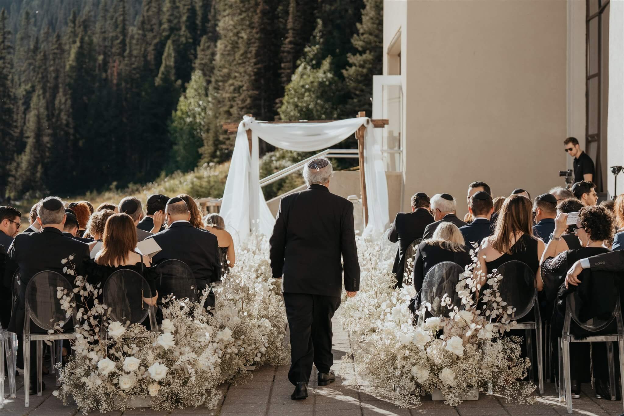 Outdoor wedding ceremony setup with white and gold wedding decorations