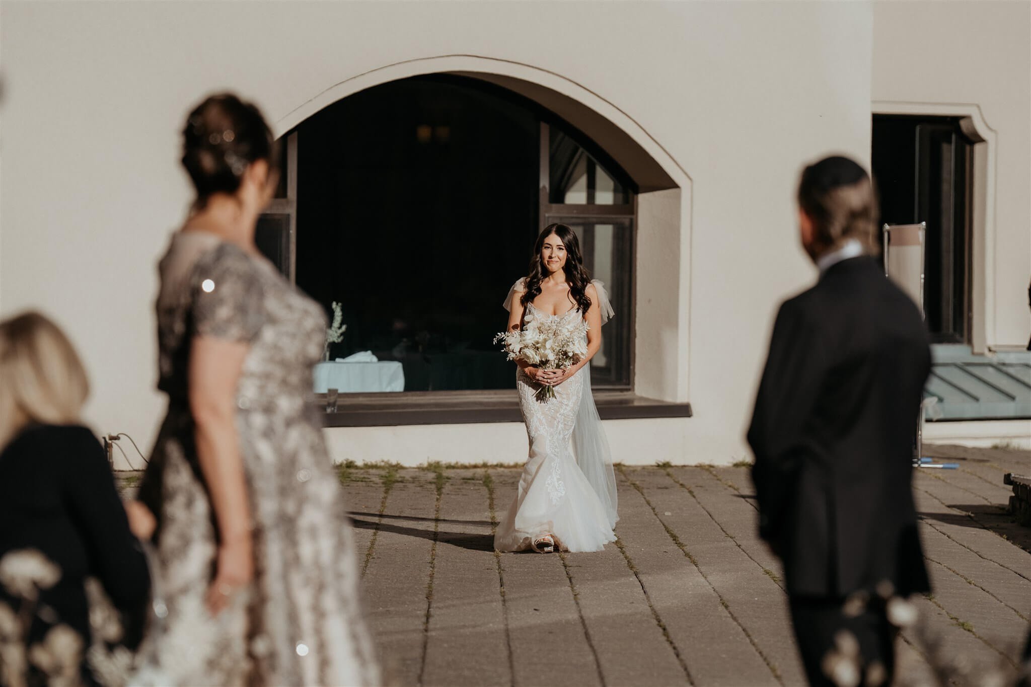 Bride enters outdoor wedding ceremony with white and gold wedding decorations