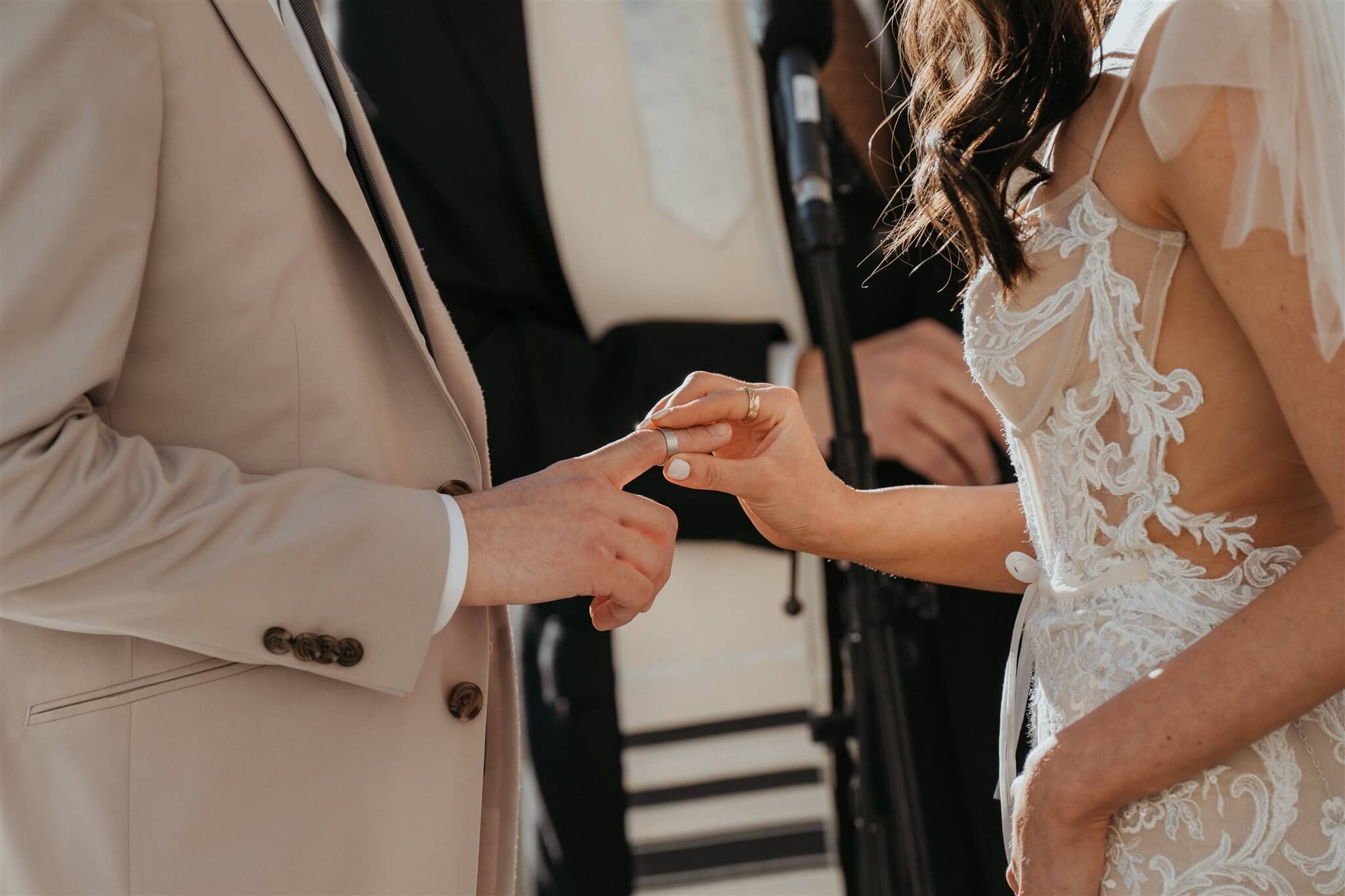 Bride and groom exchange rings at outdoor wedding ceremony at Fairmont Chateau Lake Louise