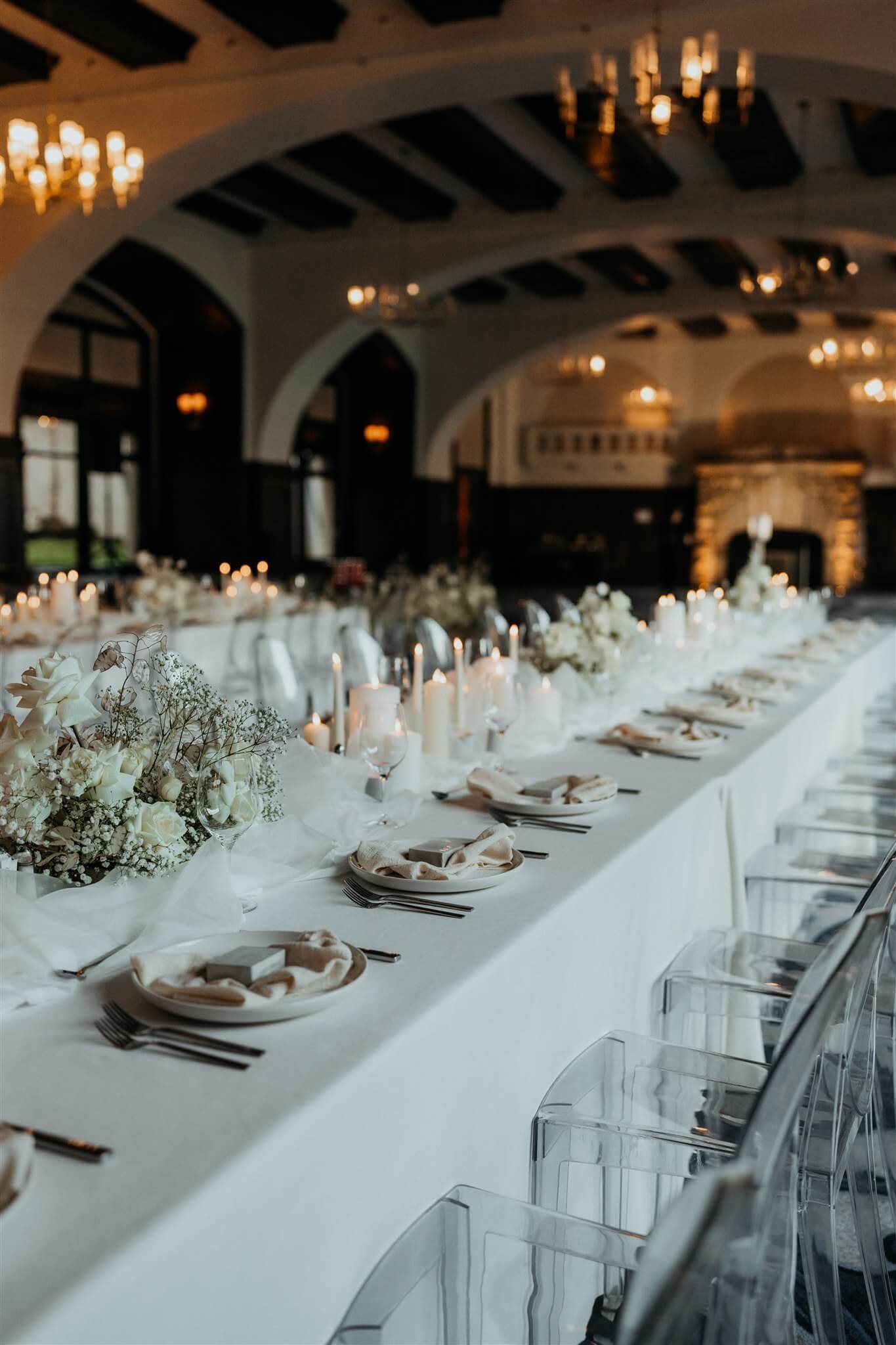 Reception table with white and gold wedding decorations