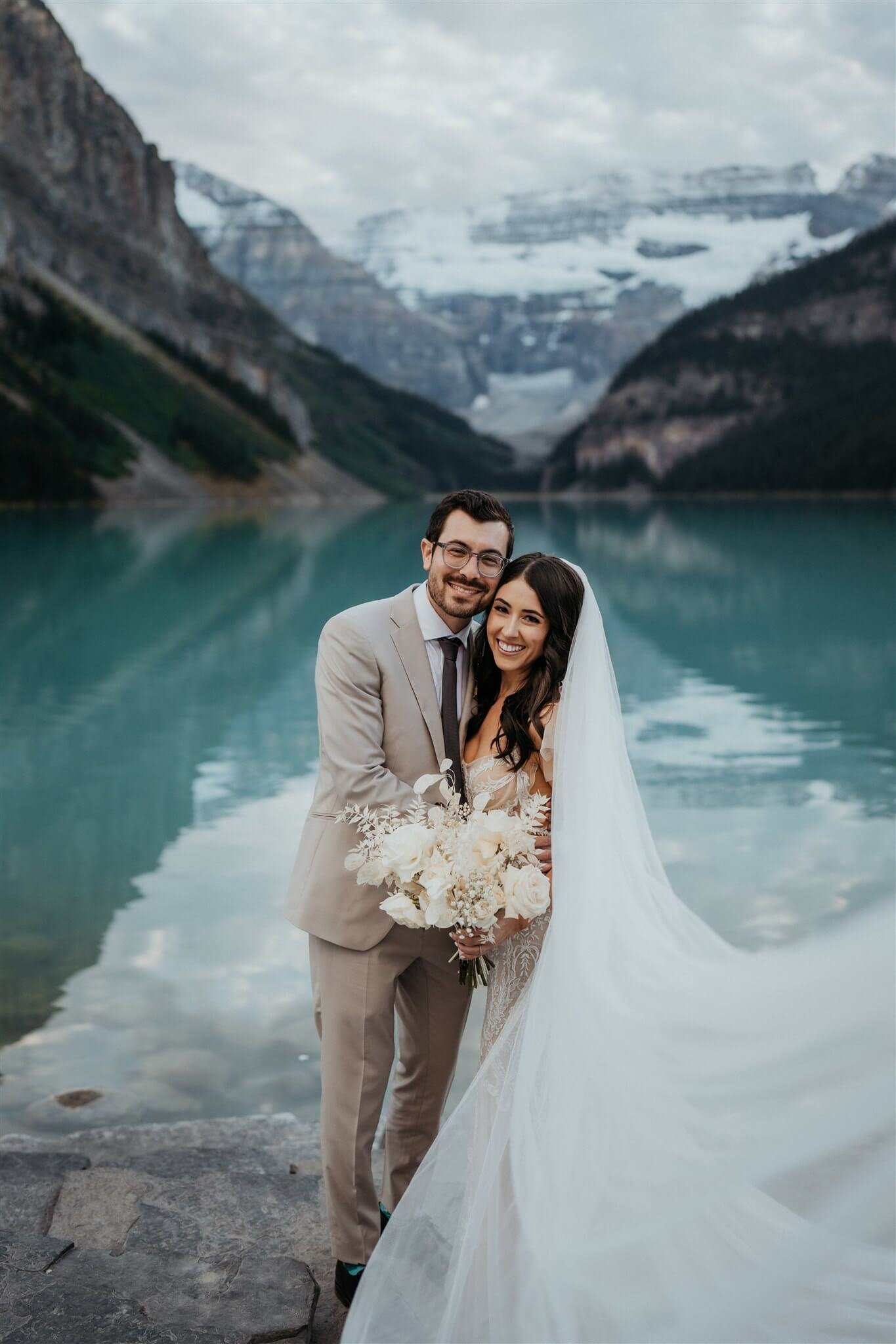 Bride and groom outdoor couple portraits at luxury venue at Lake Louise