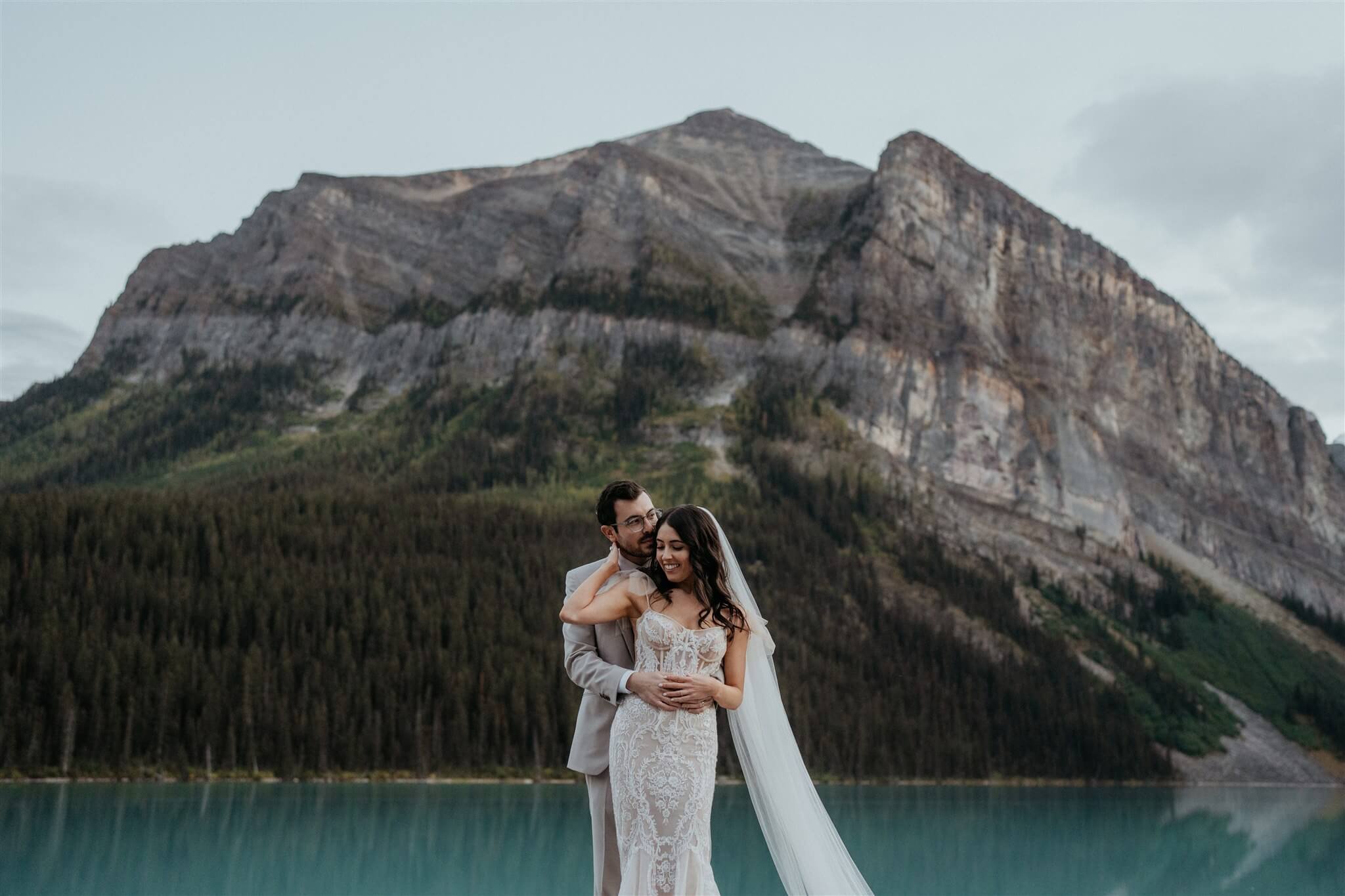 Bride and groom outdoor couple portraits at luxury venue at Lake Louise