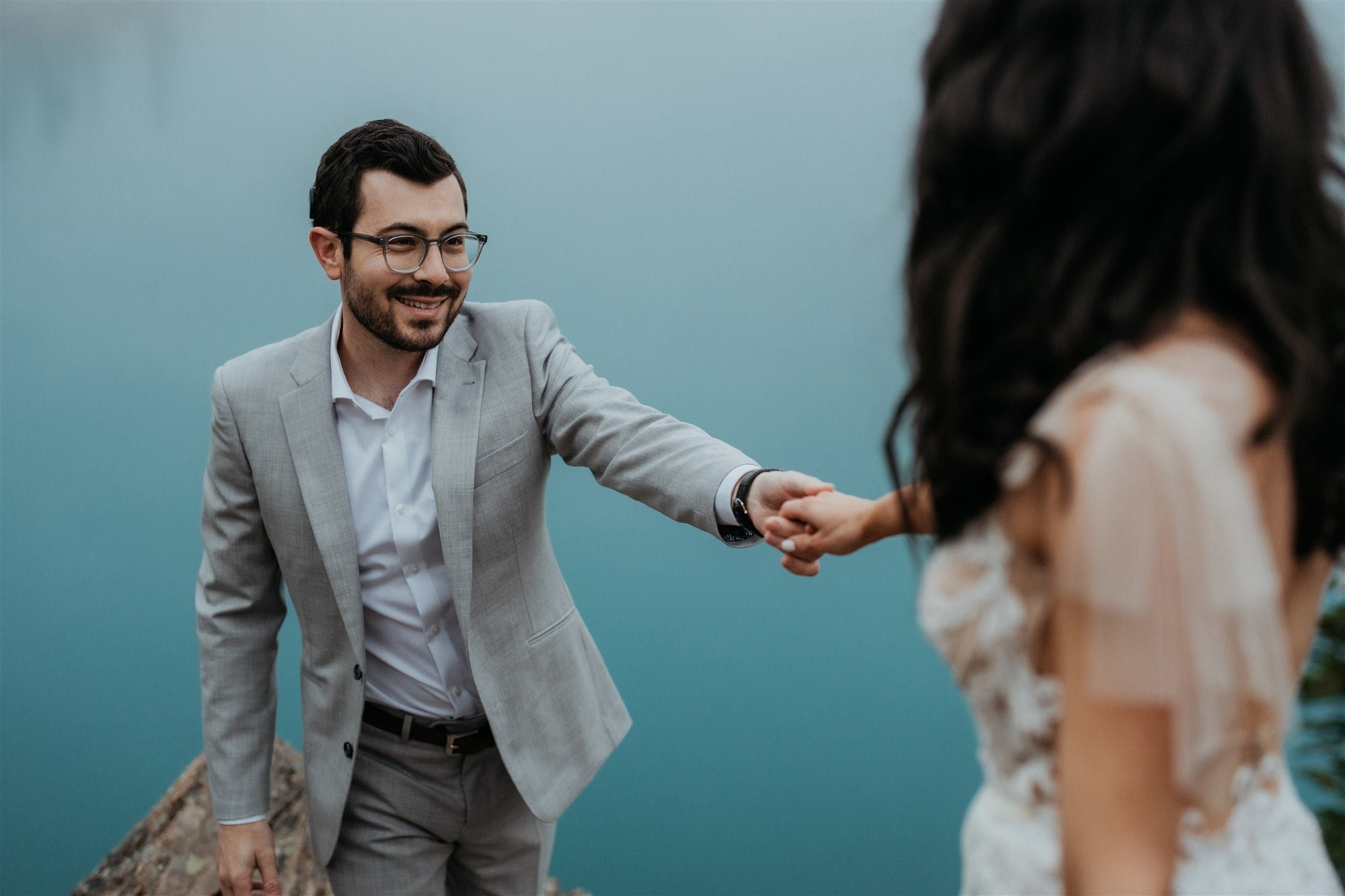 Bride and groom hold hands during Banff elopement portrait photos