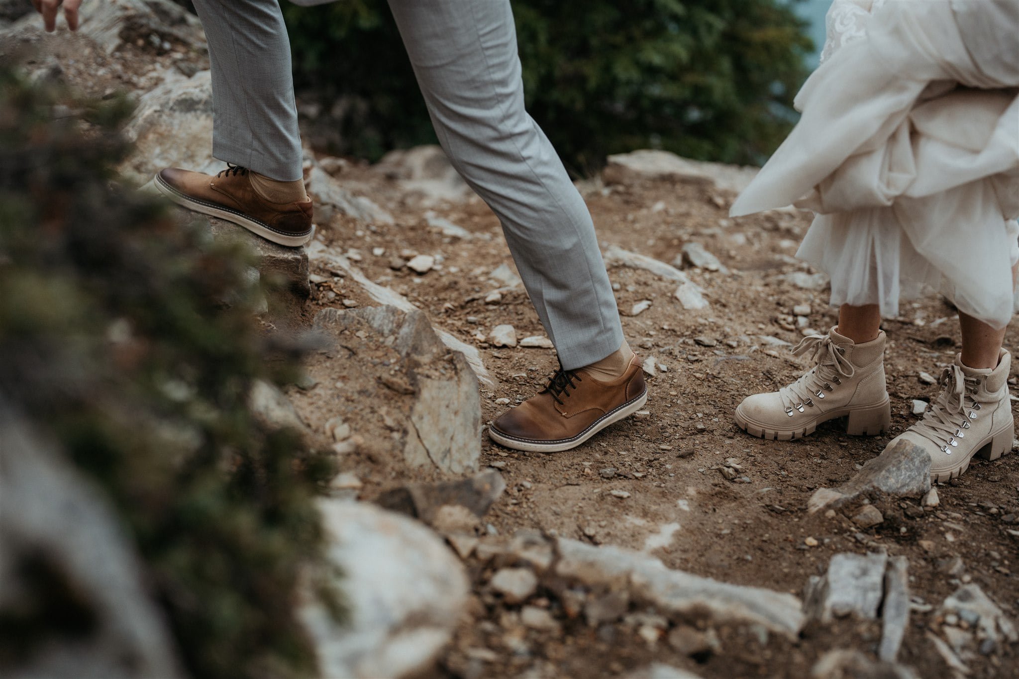 Bride and groom hiking a mountain trail during their adventure elopement in Banff