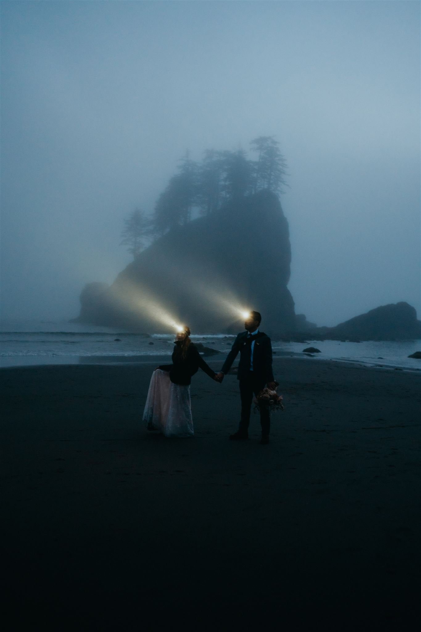 Bride and groom wearing headlamps during blue hour wedding portraits at La Push Beach