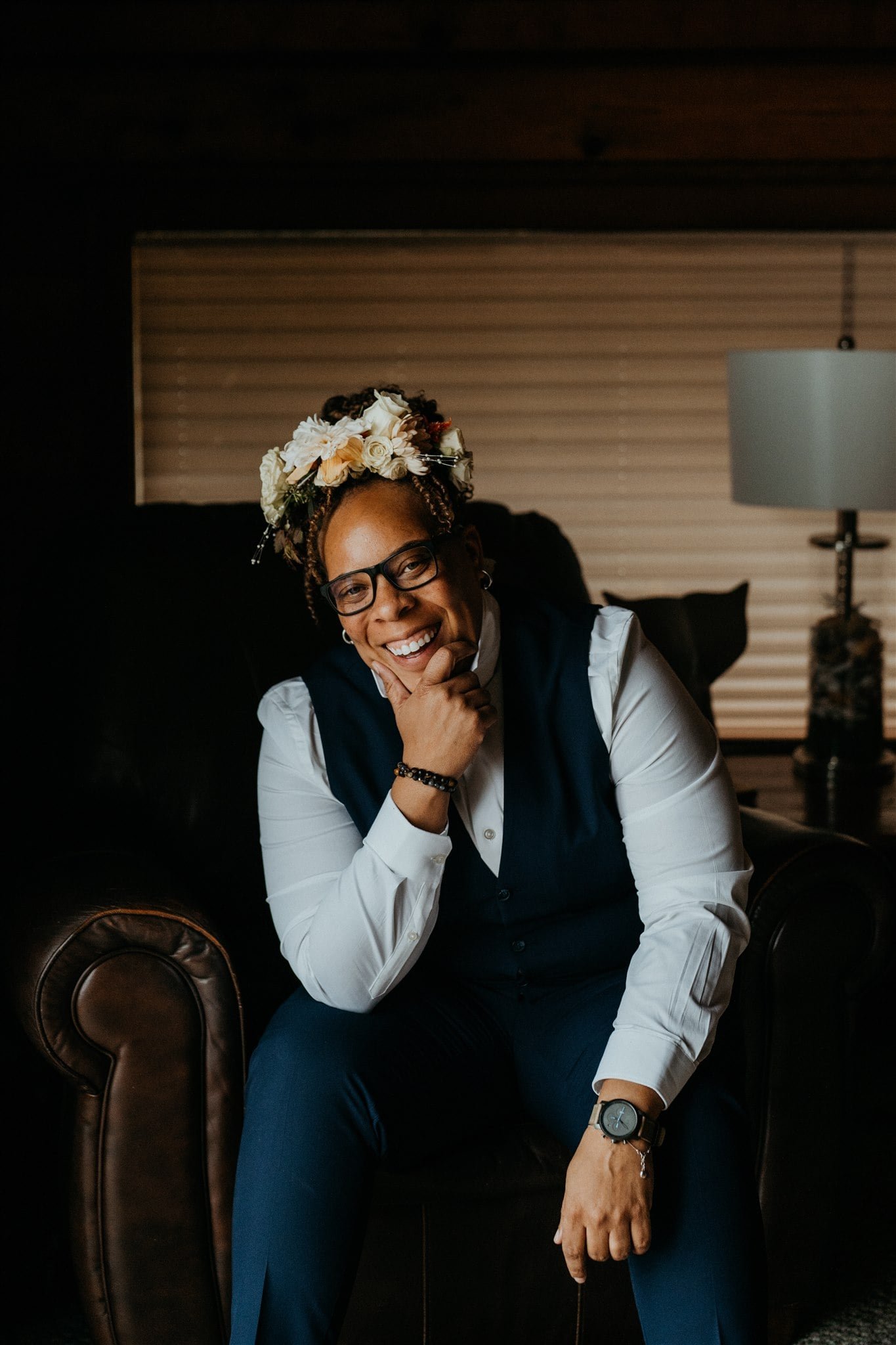 Bride wearing a floral crow and blue three piece suit