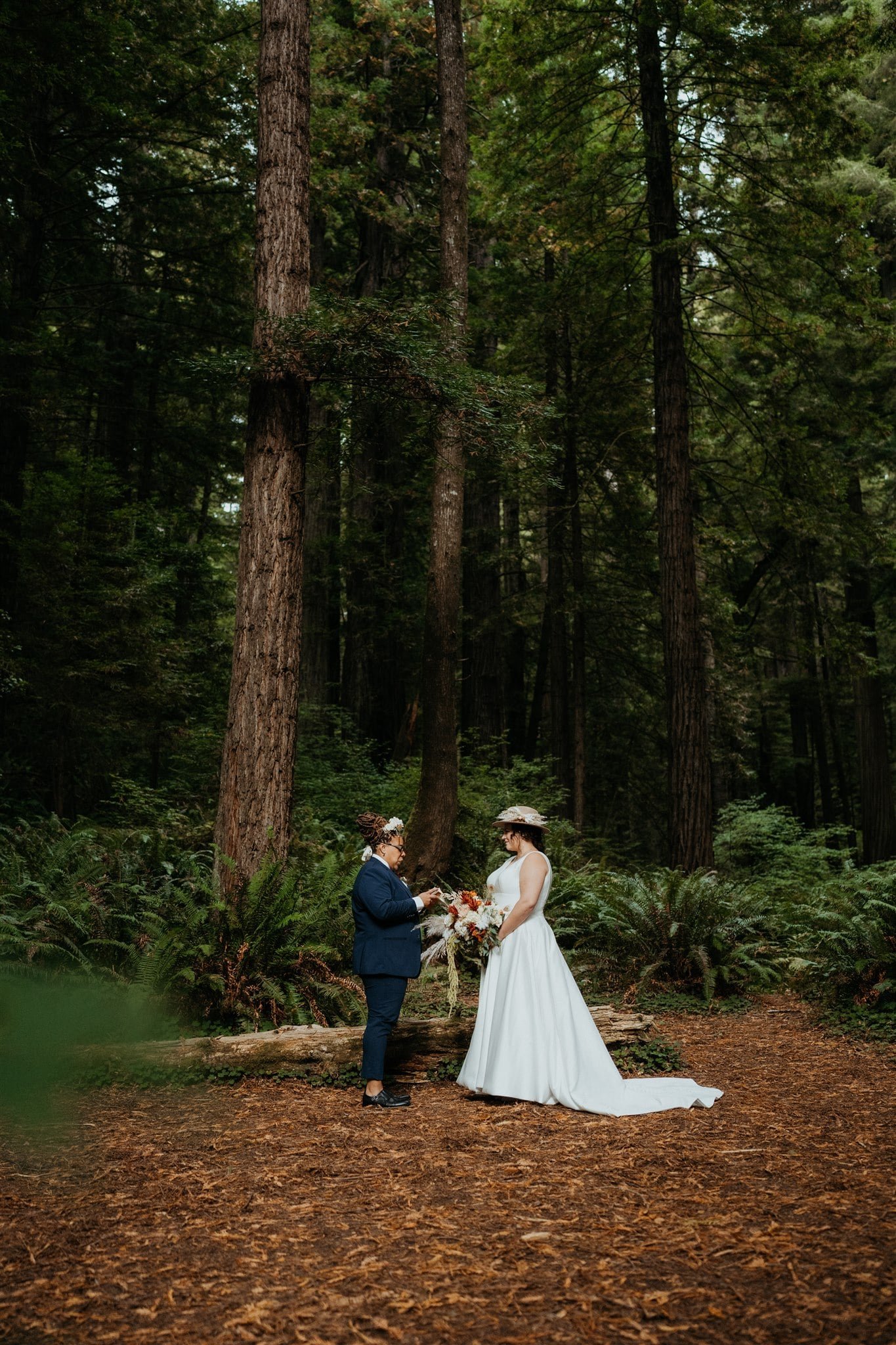 Two brides exchange vows during forest elopement ceremony on the Southern Oregon Coast
