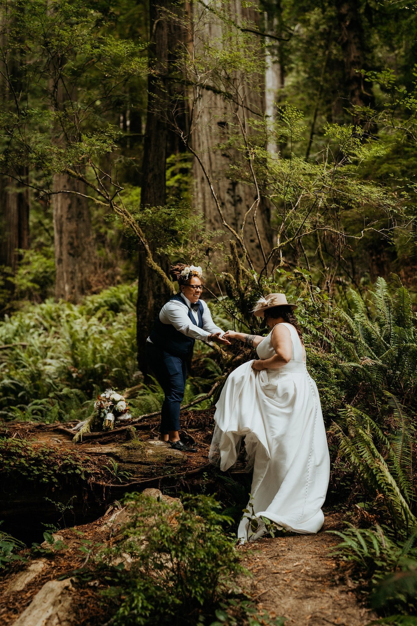 Brides hike through the forest during their Southern Oregon Coast elopement