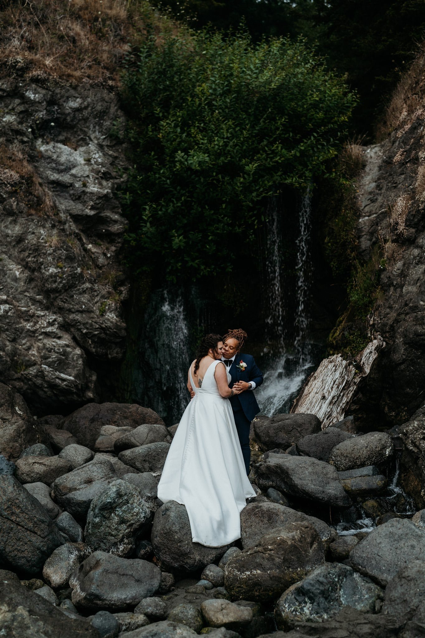 Bridal portraits in front of a waterfall on the beach on the Oregon Coast