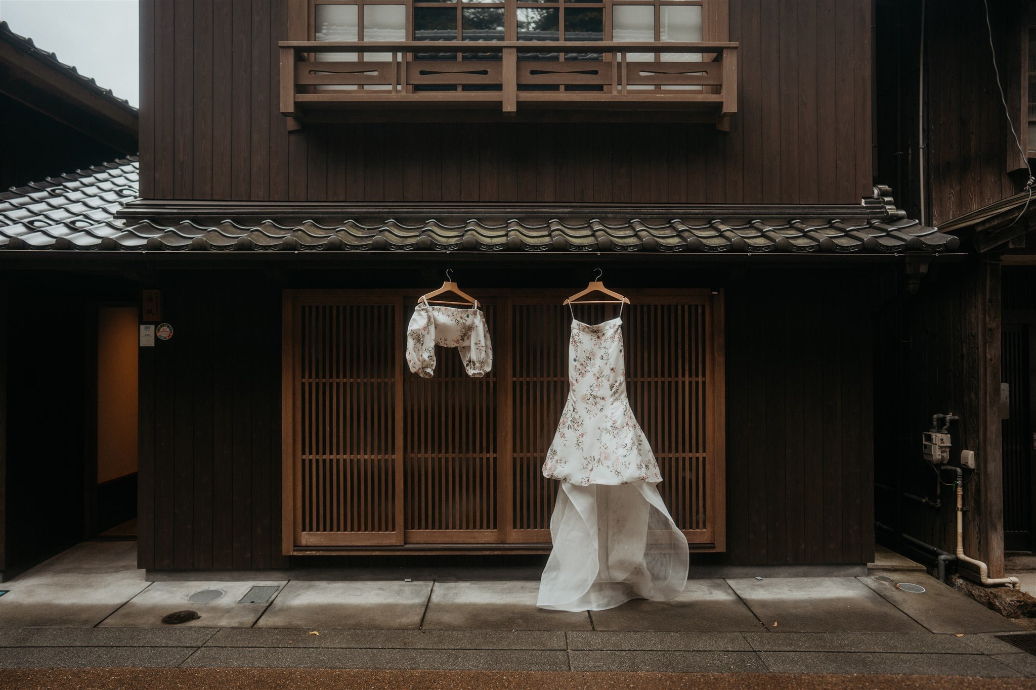 Two piece wedding dress hanging from elopement cabin