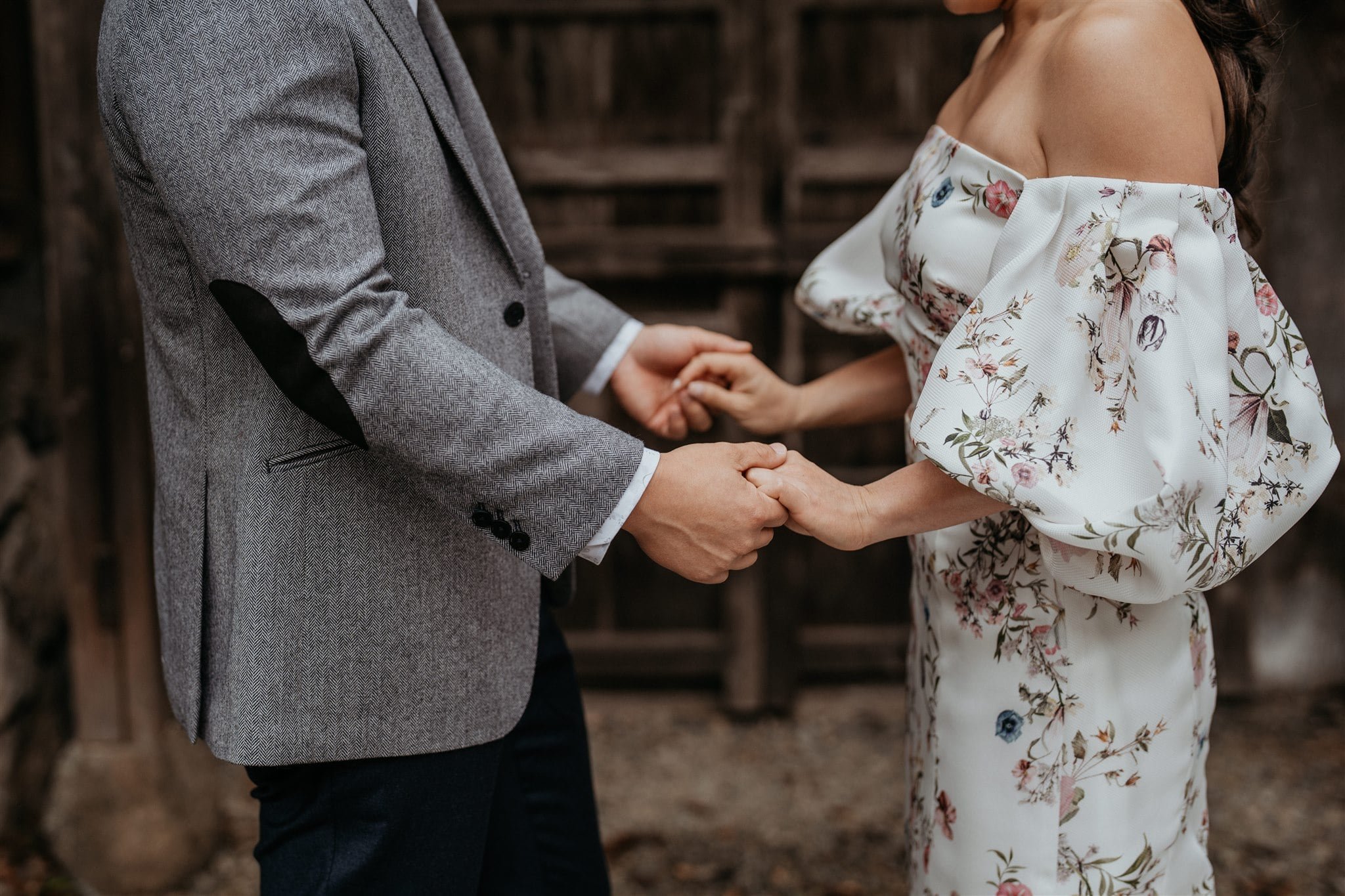 Bride and groom holding hands during first look 