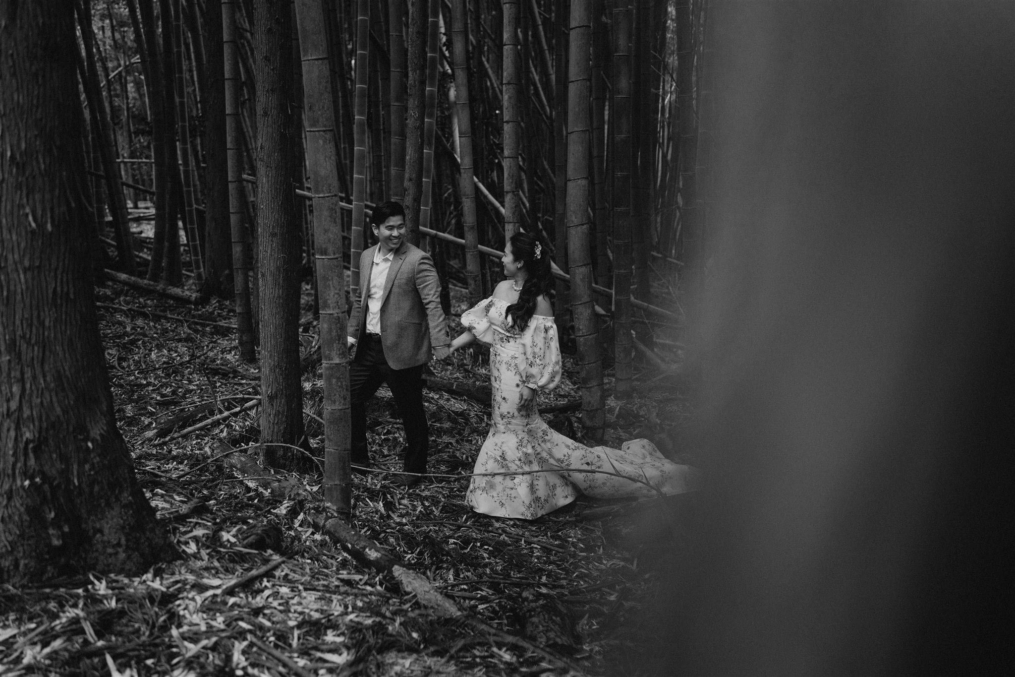 Bride and groom holding hands while walking through a bamboo forest during their Japan elopement