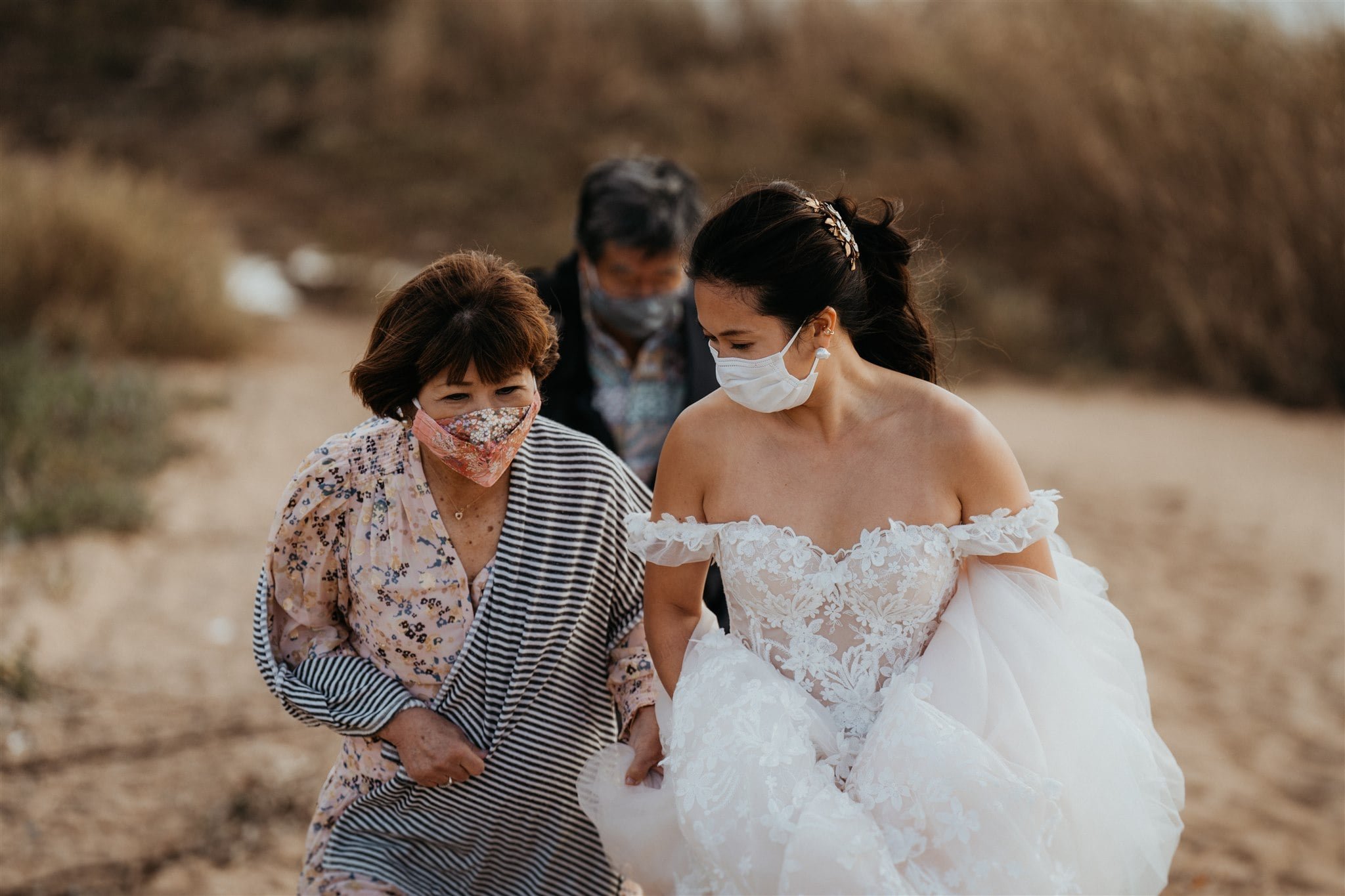 Brie and parents walking along the beach for outdoor elopement ceremony