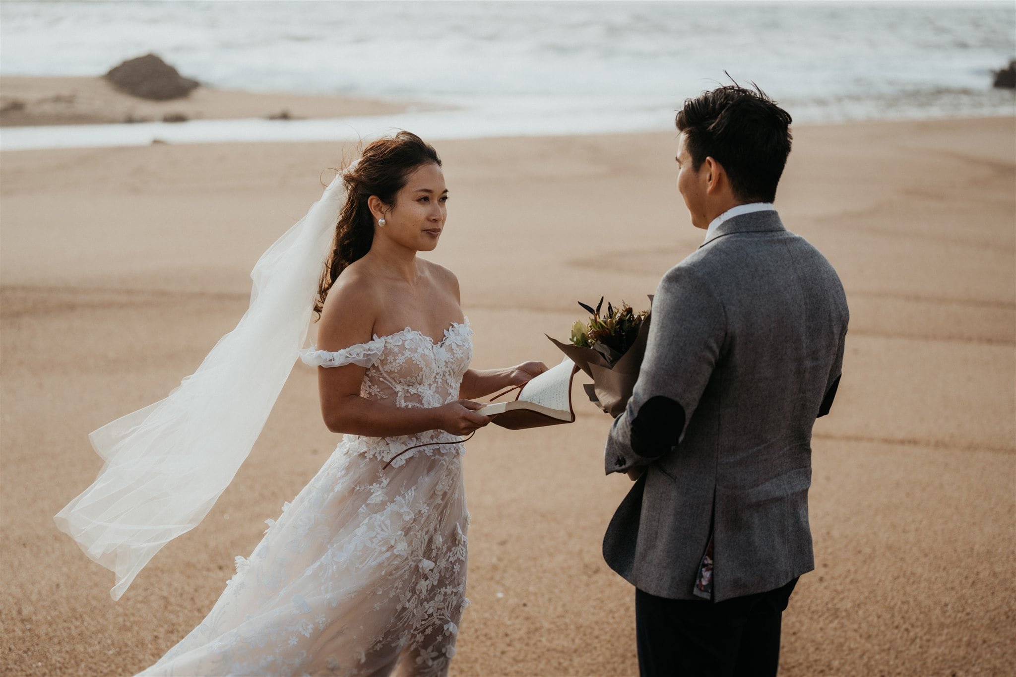 Bride and groom exchange vows on the beach during Japan elopement