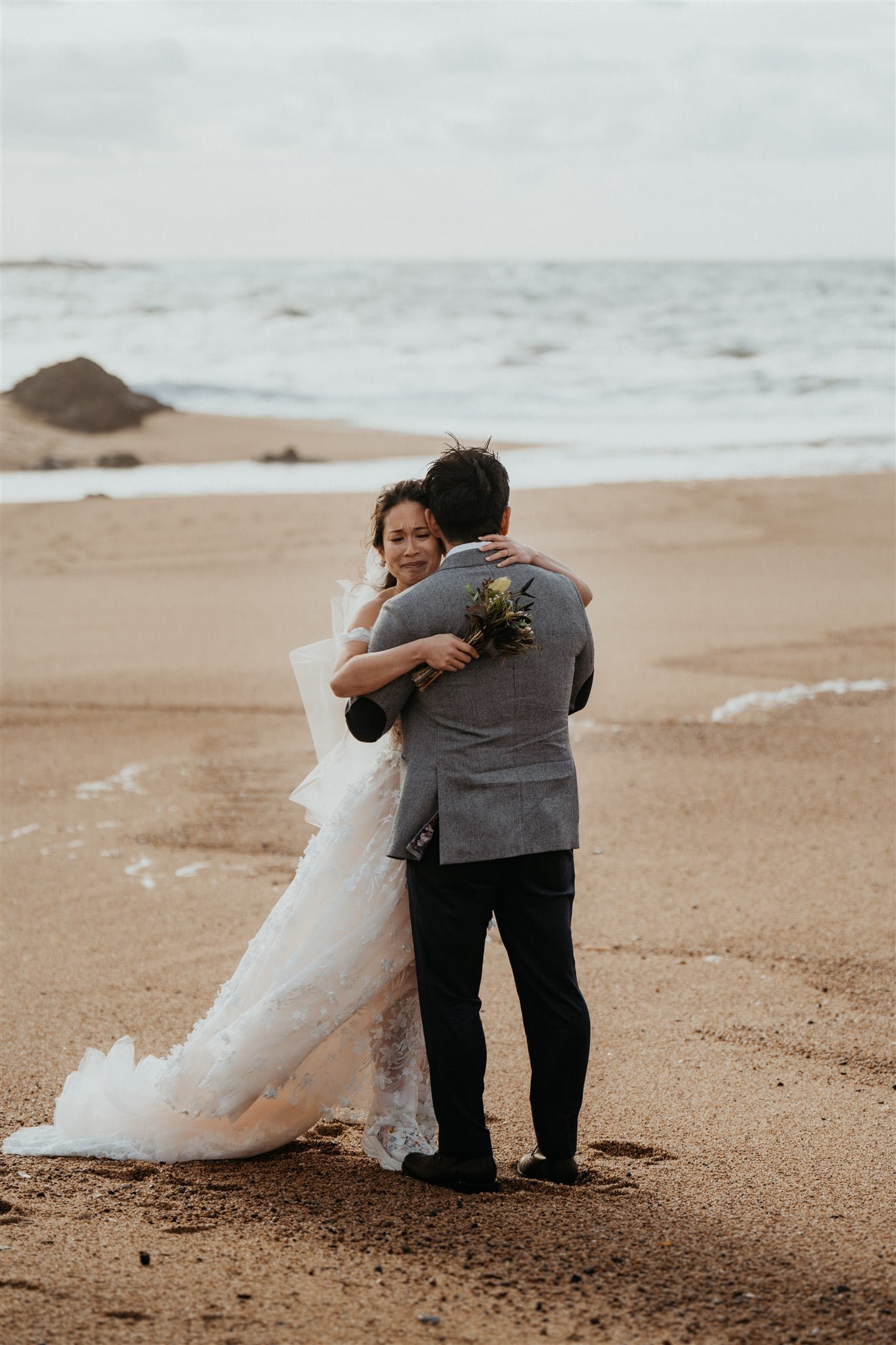 Bride and groom hug after exchanging vows on the beach during their Kyoto, Japan elopement
