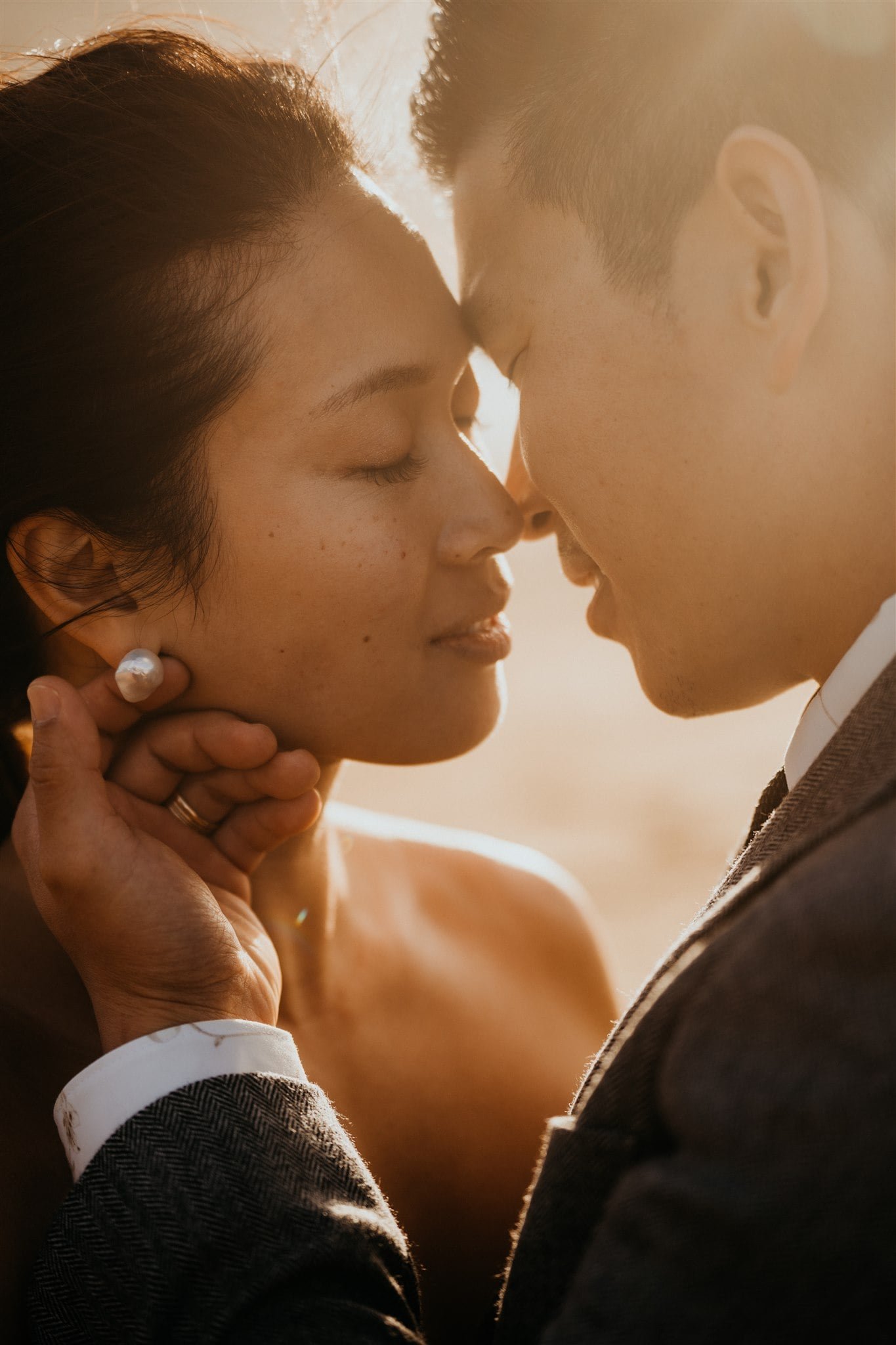 Bride and groom kiss during their elopement portraits on the beach in Kyoto, Japan