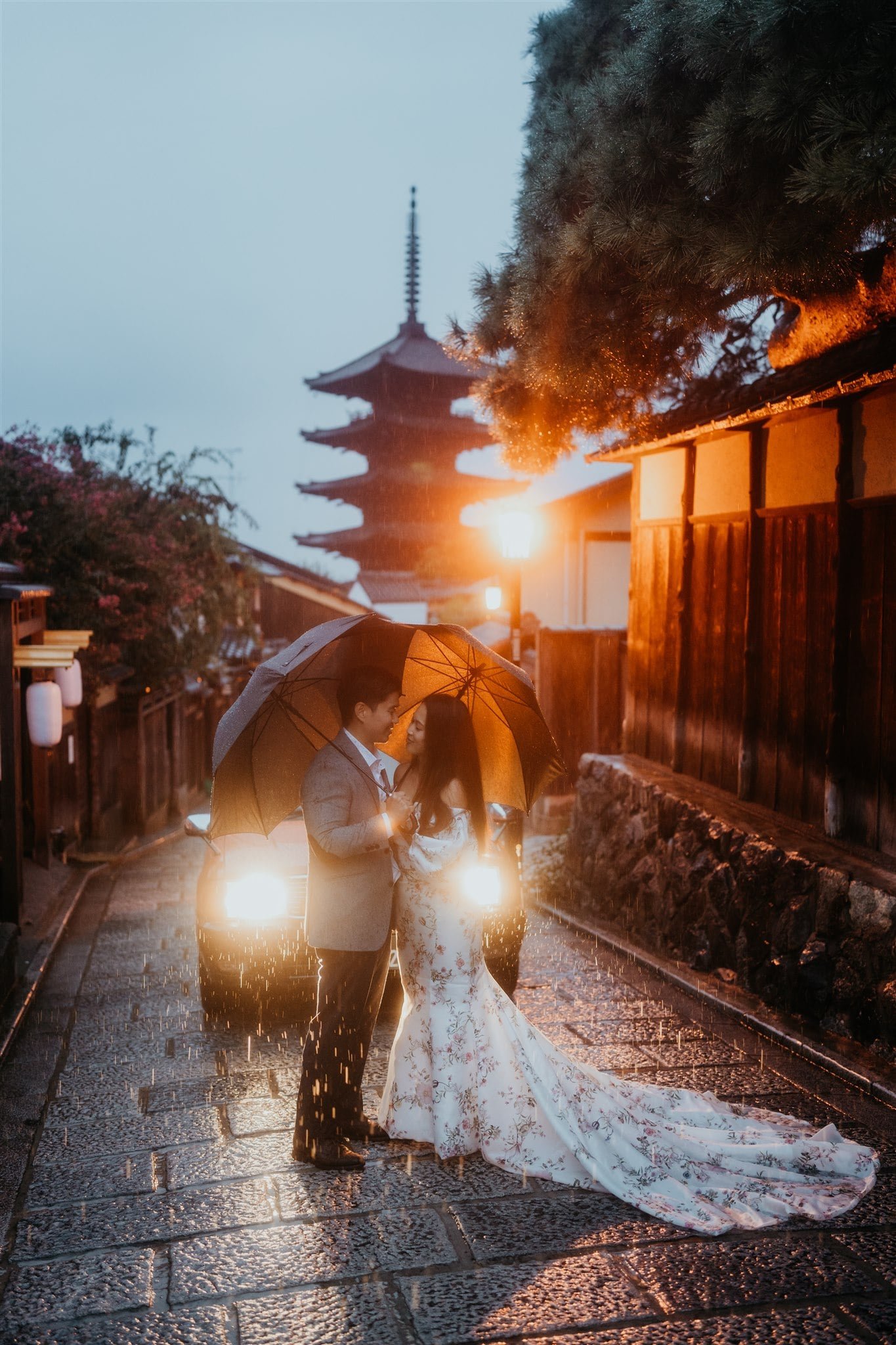 Bride and groom kiss in the streets of Kyoto during blue hour