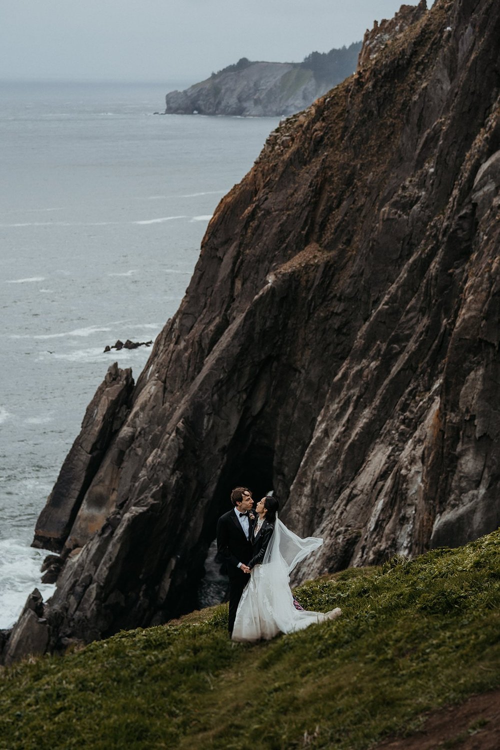 Bride and groom portraits on the cliff on the Oregon Coast