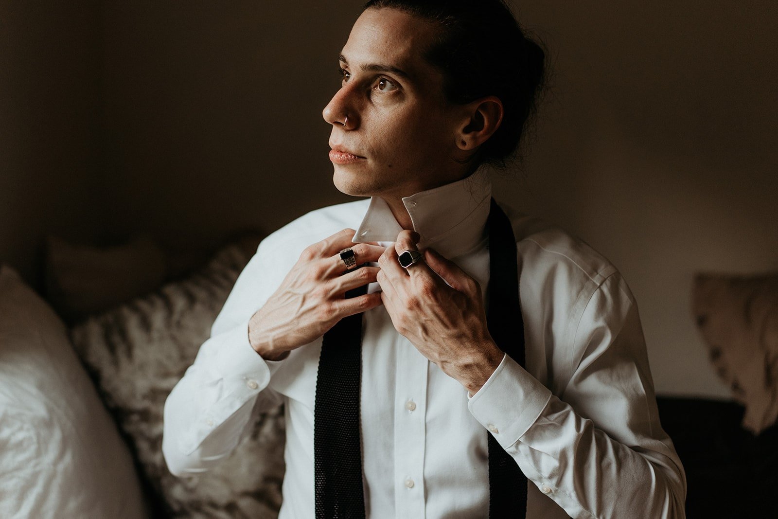 Groom adjusting tie while getting ready for elopement at Rialto Beach