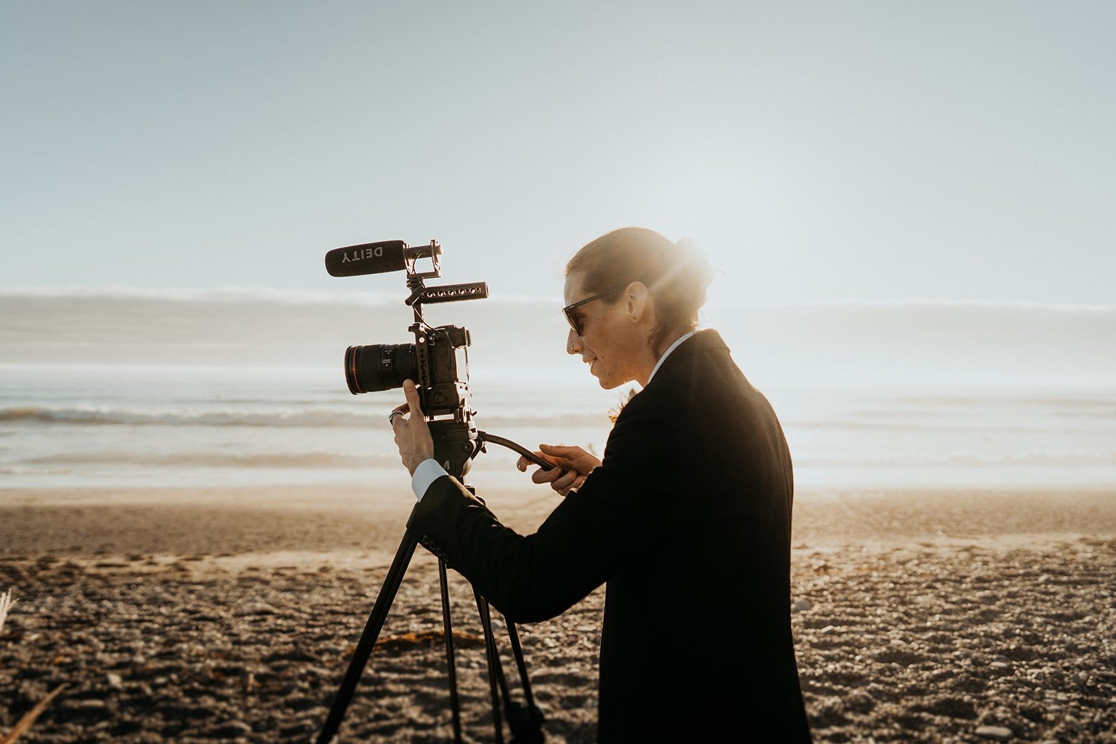 Groom setting up video camera for elopement at Rialto Beach