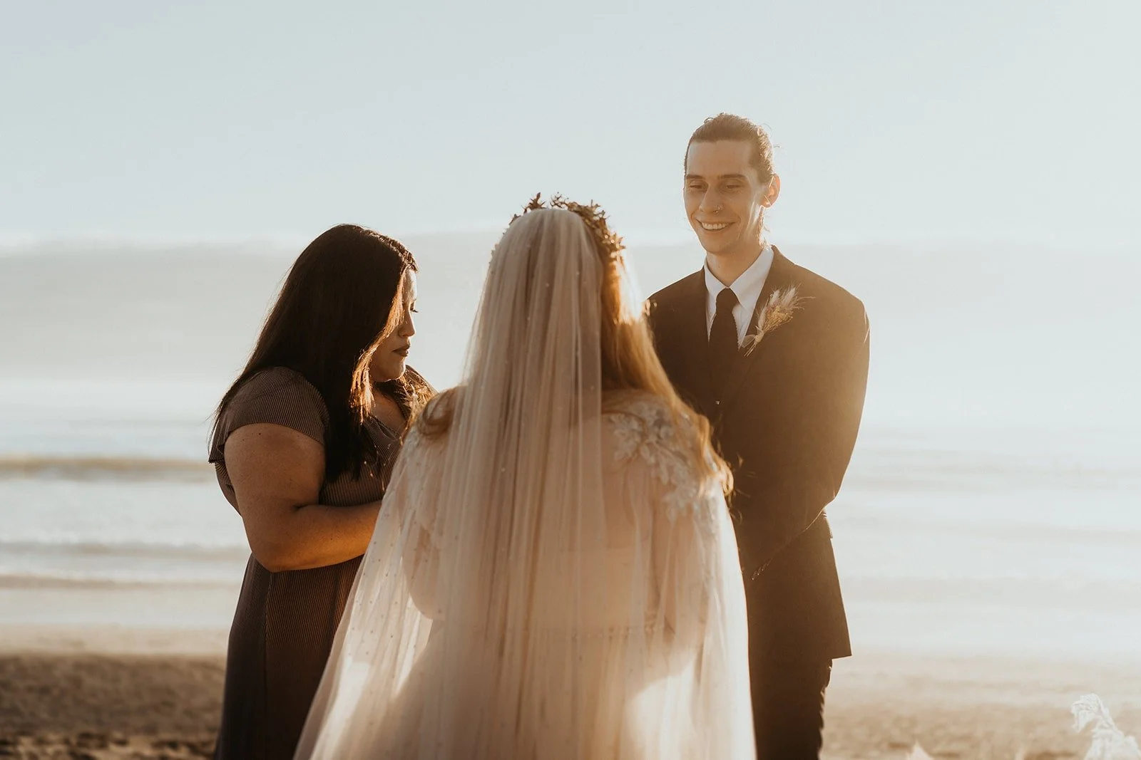 Bride and groom exchange vows during outdoor wedding ceremony on the beach at Rialto Beach elopement