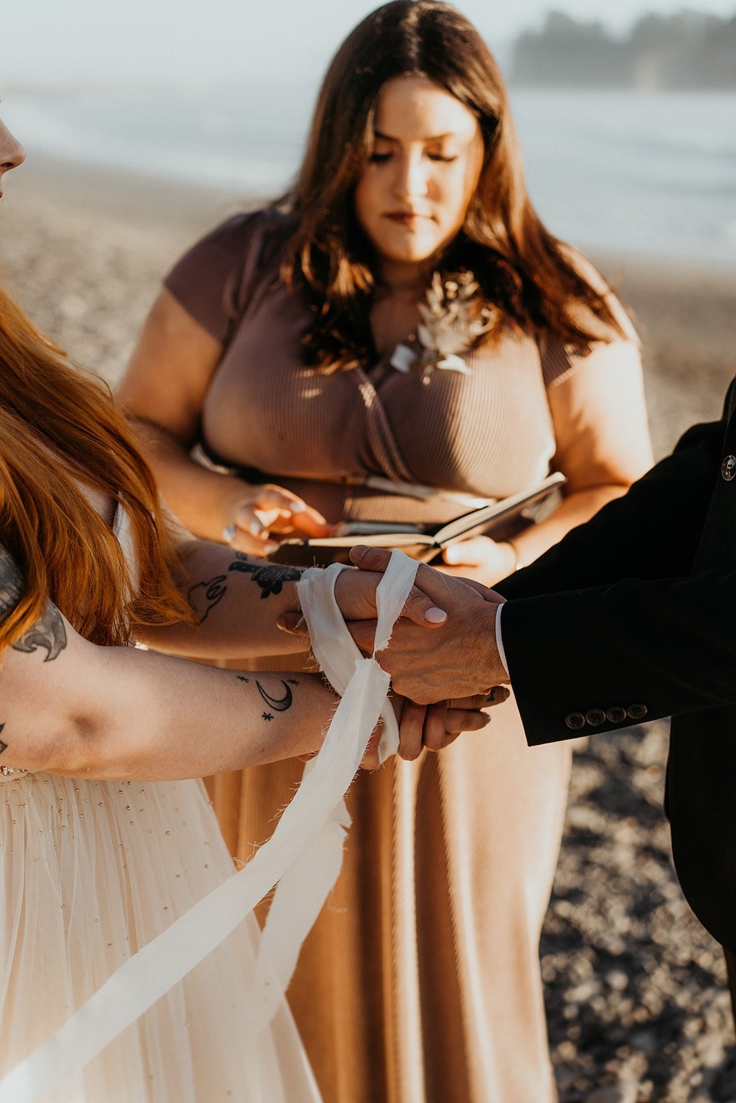 Hand fasting ceremony at Rialto Beach elopement