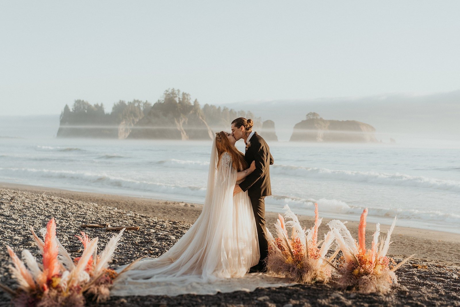Bride and groom kiss during elopement at Rialto Beach