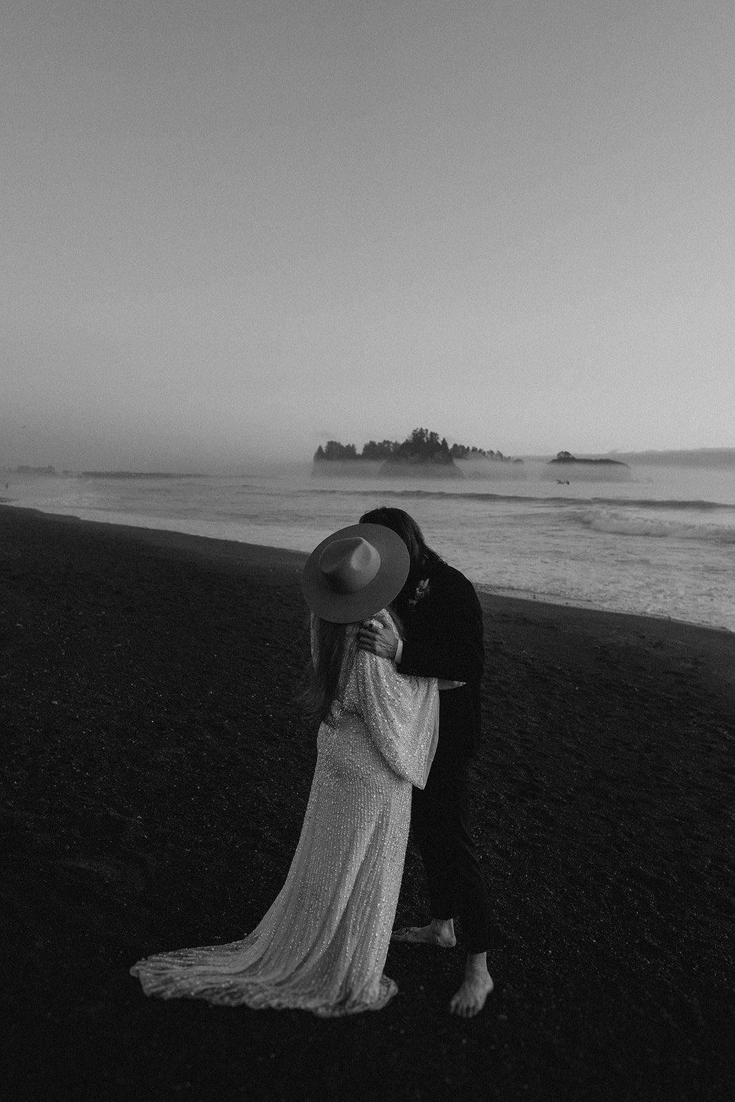 Bride and groom kiss during blue hour at their Rialto Beach elopement