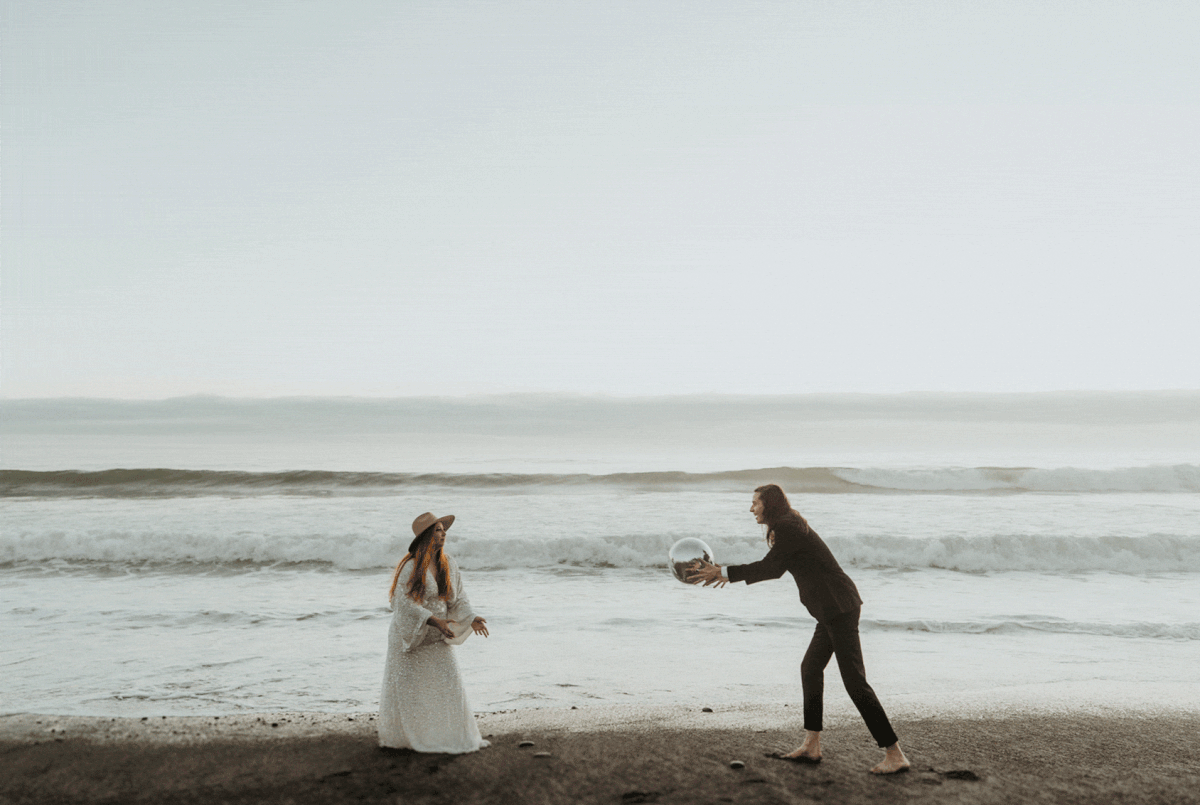 Bride and groom toss a disco ball on the beach at Rialto Beach