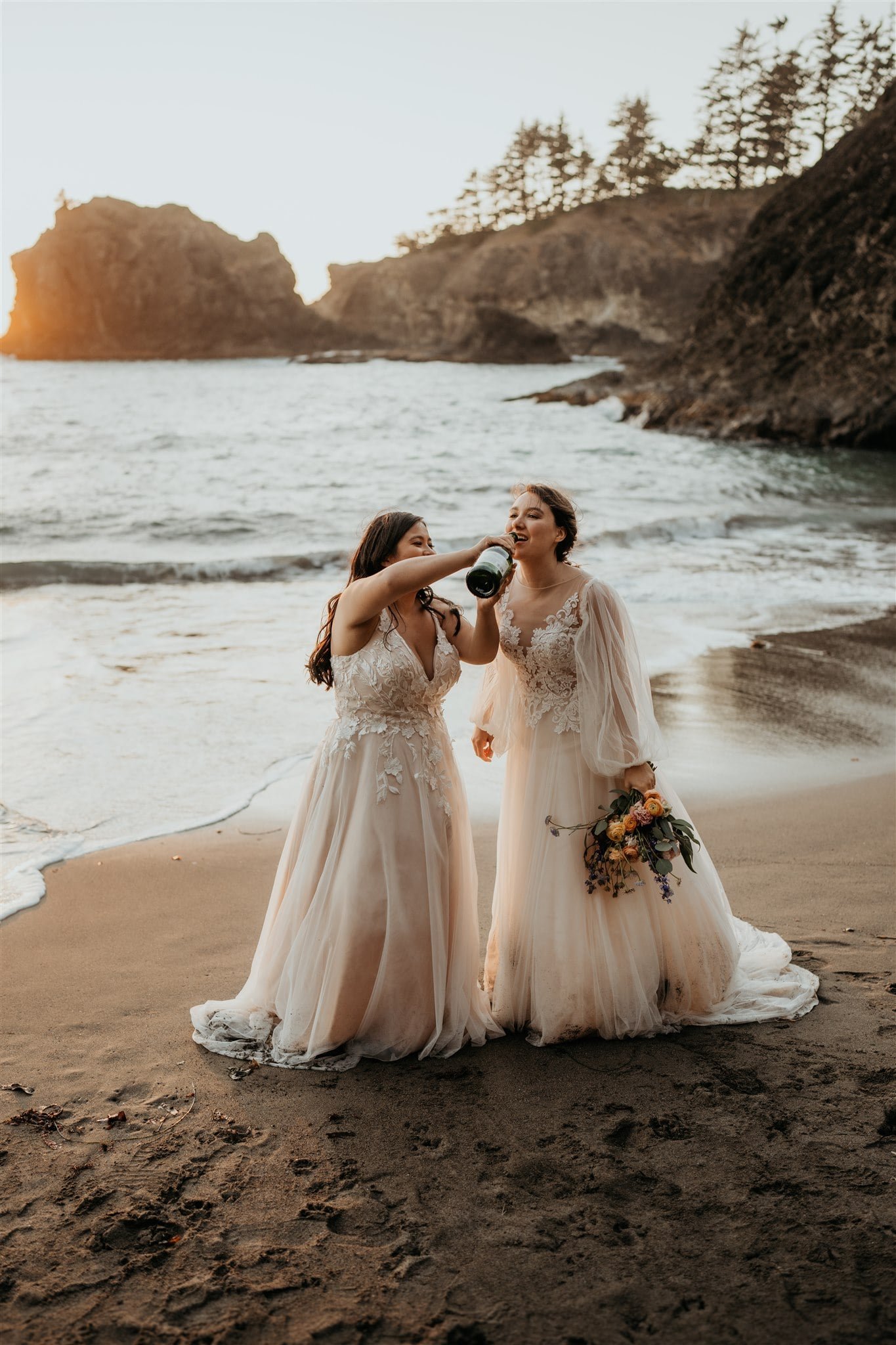 Brides drinking champagne during their elopement at Secret Beach
