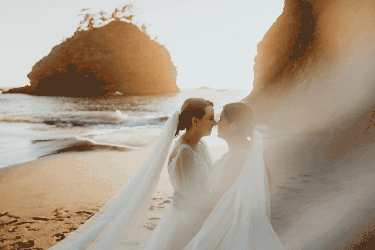 Brides kiss during sunset bridal portraits on the beach during elopement at Secret Beach, Oregon