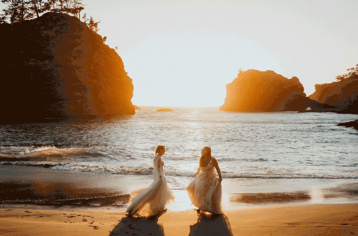 Brides dancing on the beach during sunset at their elopement at Secret Beach, Oregon