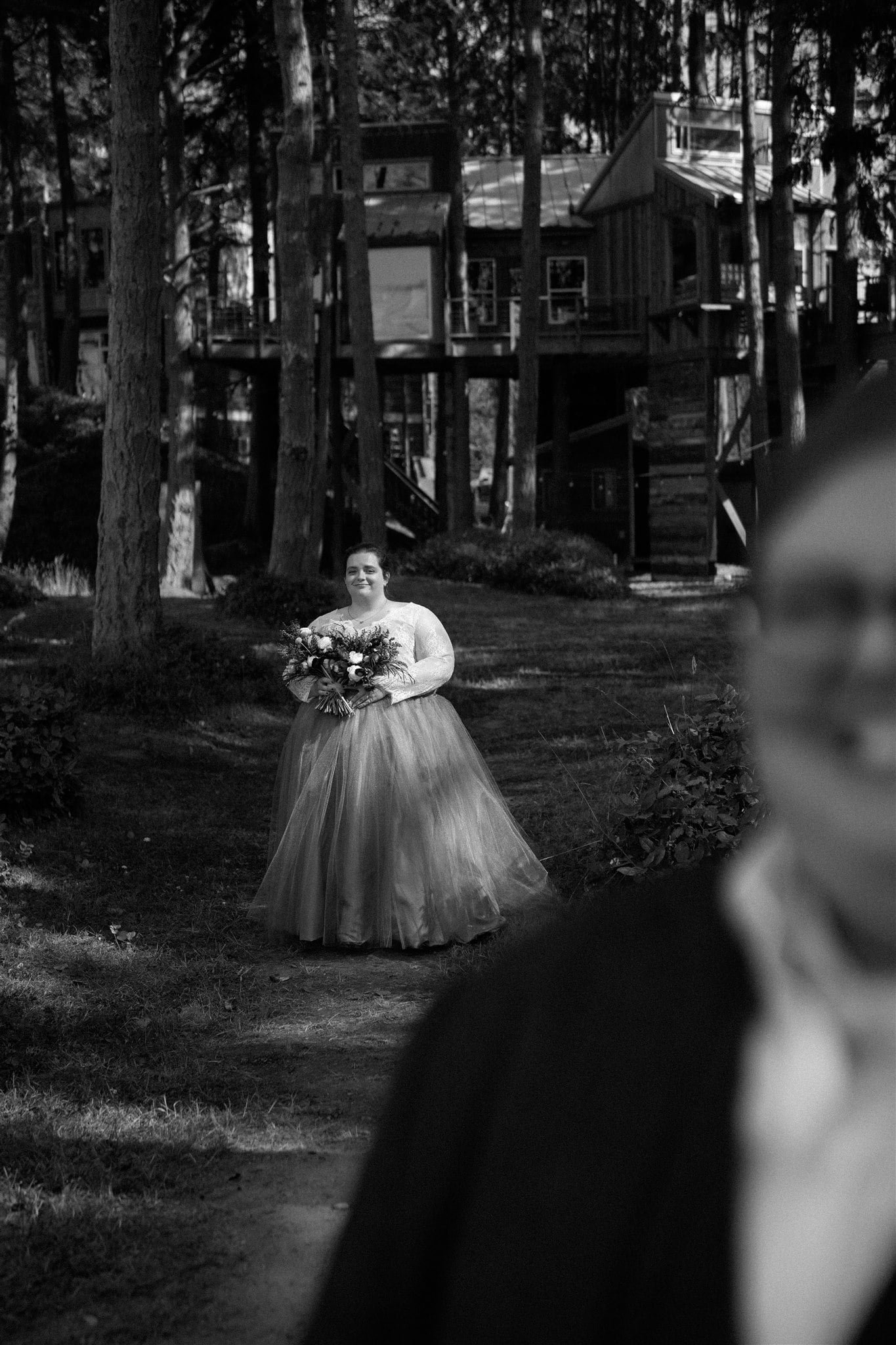 Bride walking down the forest trail for her elopement first look 