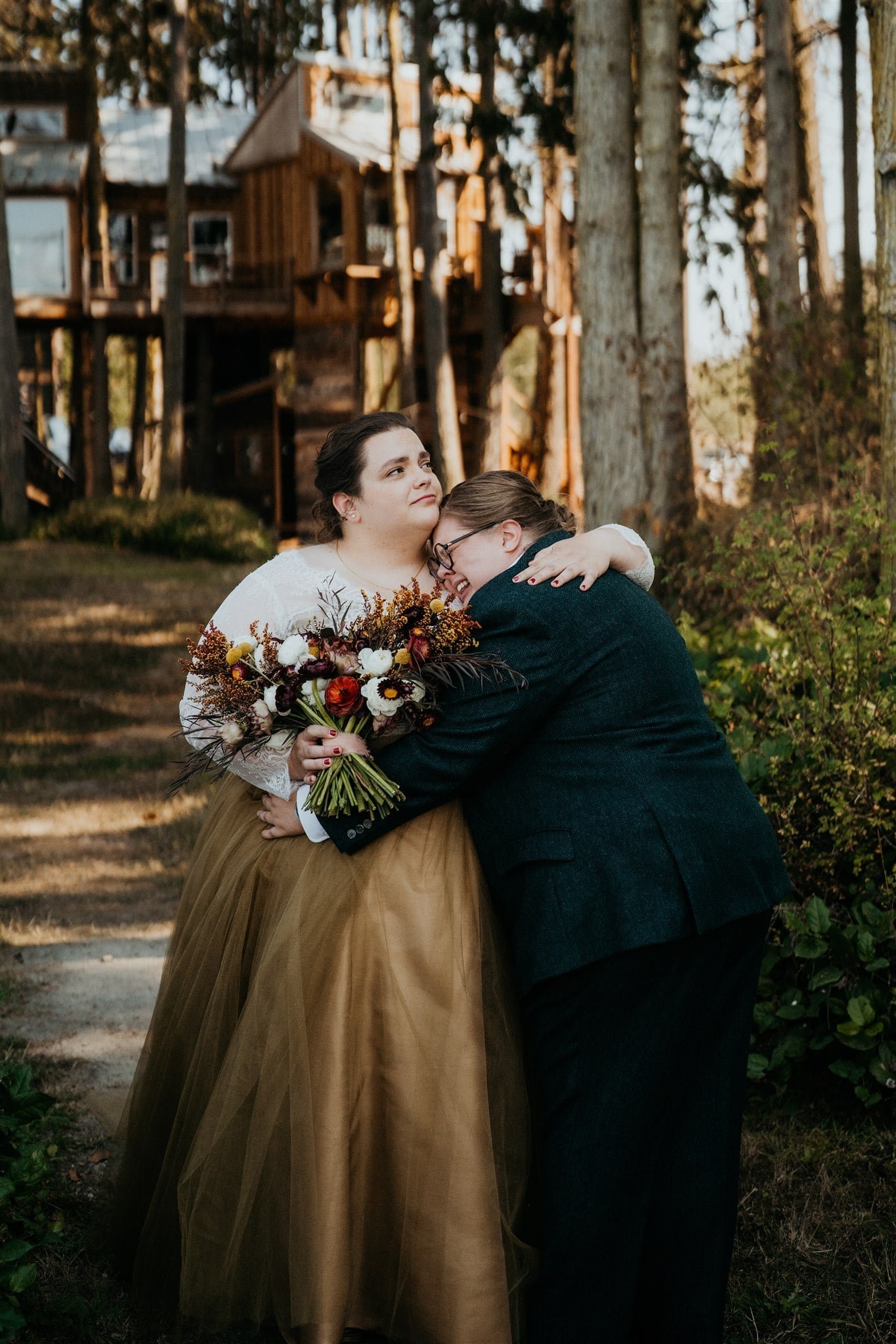 Brides hug and get emotional after first look in the forest in Olympic National Park